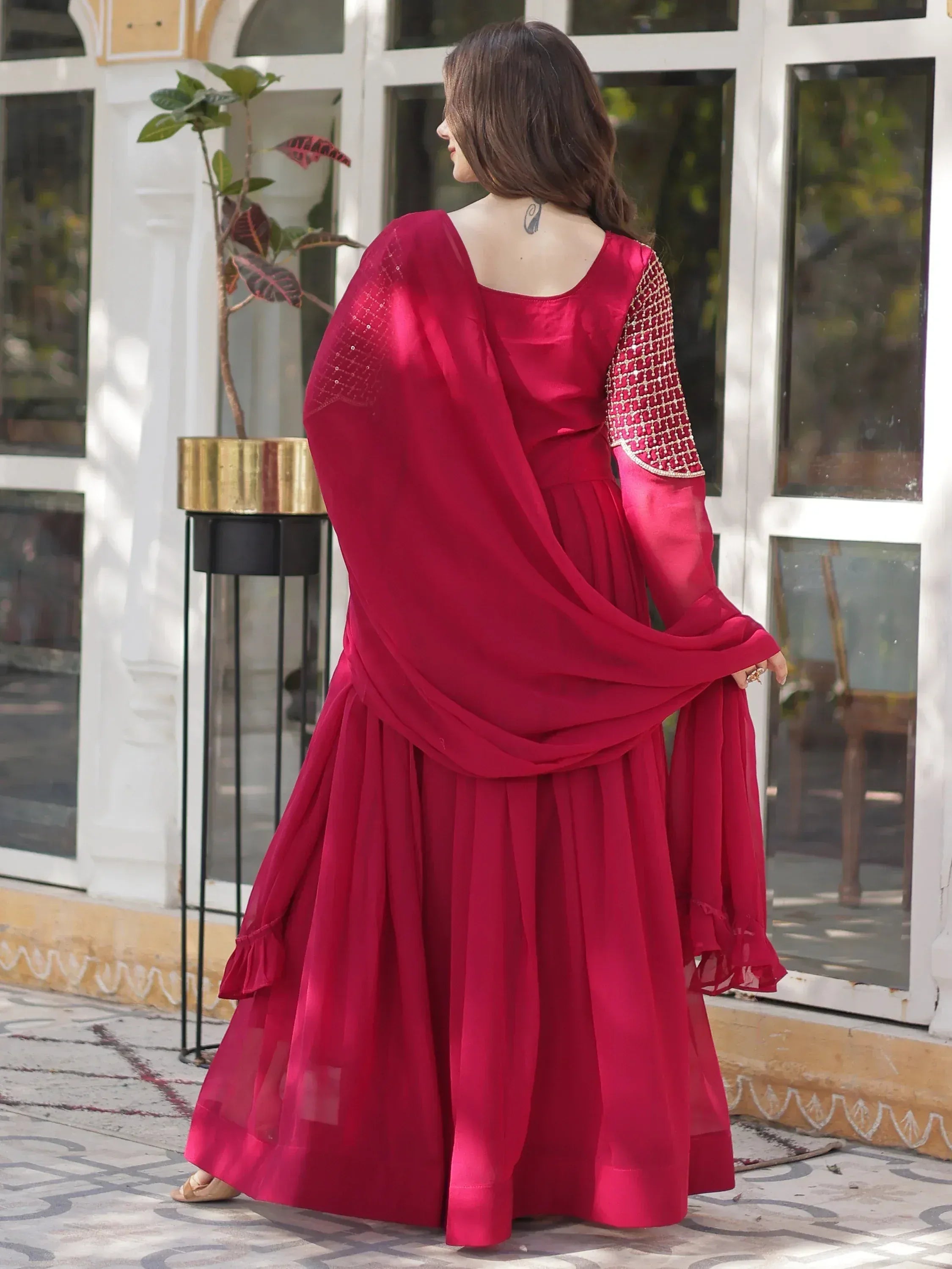 Red ethnic anarkali suit with embroidered sleeves and dupatta, perfect for festive occasions