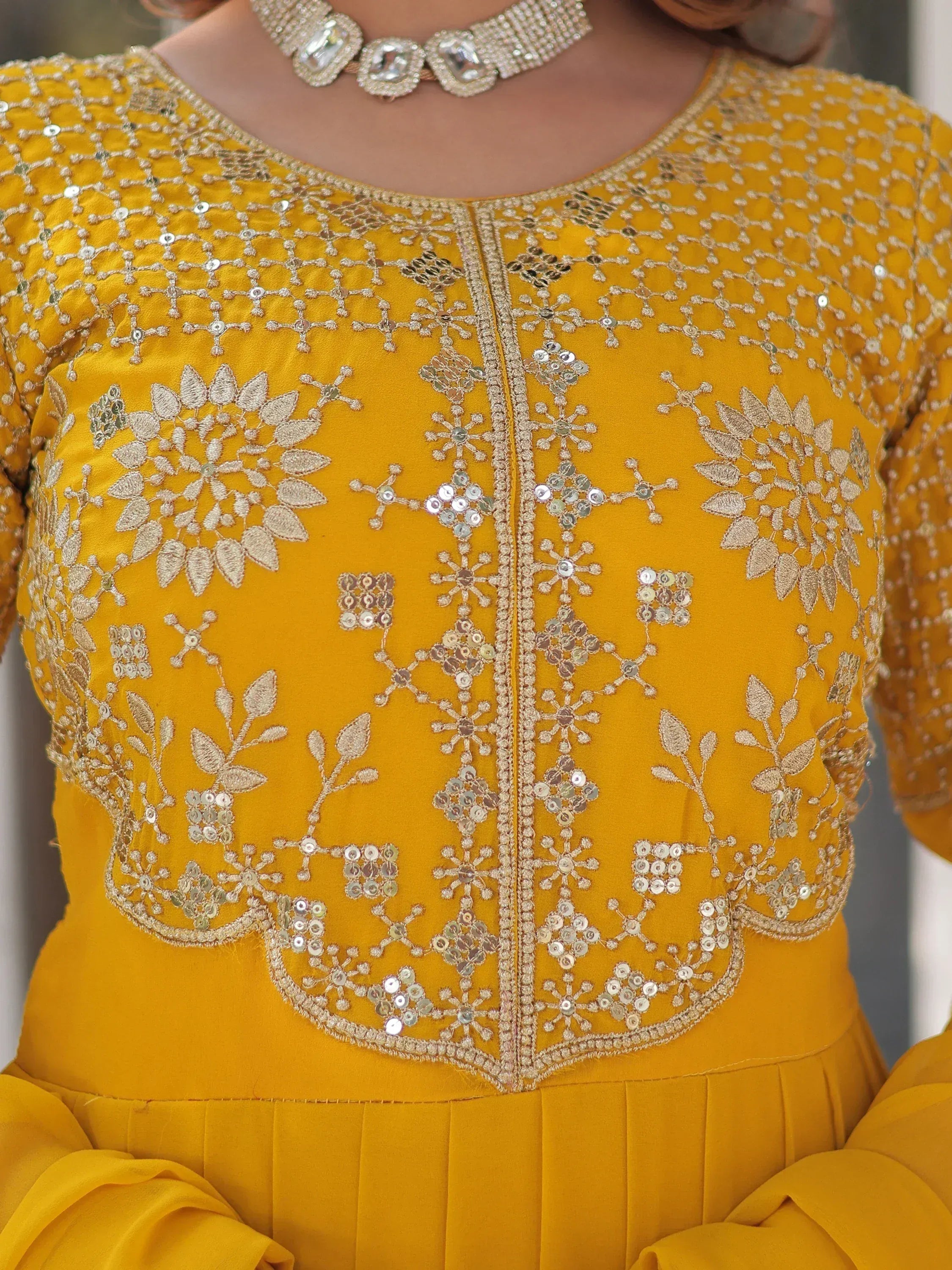 Yellow ethnic gown with gold floral embroidery and sequin detailing, perfect for Indian celebrations