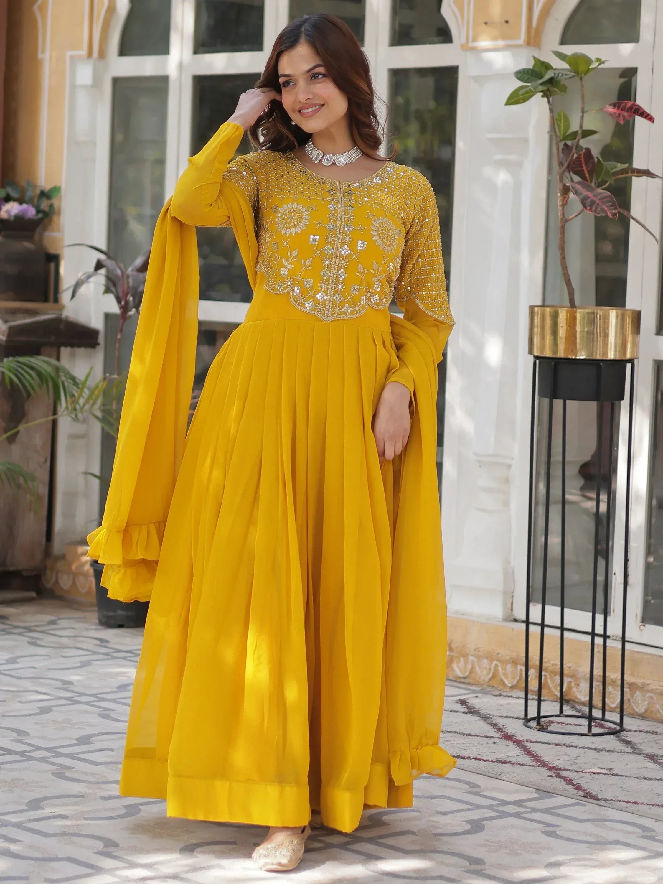 Yellow embroidered ethnic gown with pleated skirt and flared sleeves for women