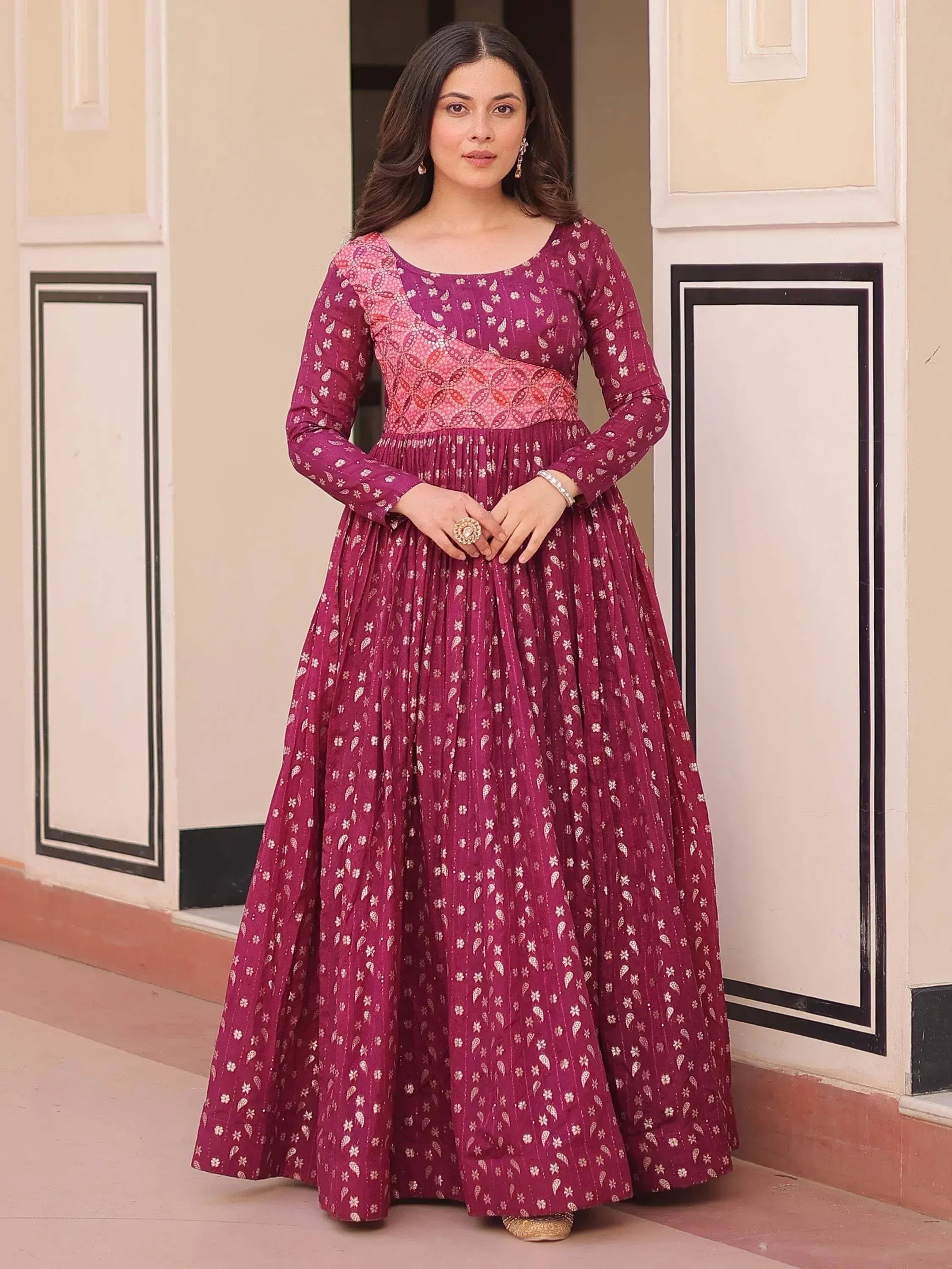 Elegant maroon ethnic gown with floral print, perfect for Indian celebrations and events.