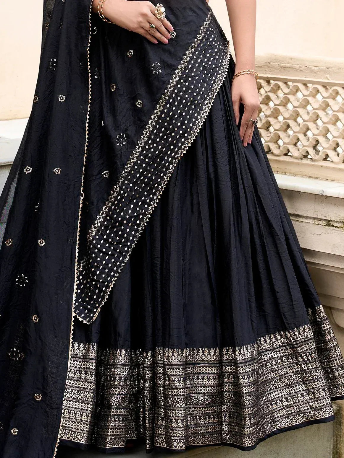 Black lehenga choli with gold embroidery and detailed border, perfect for Indian ethnic wear occasions