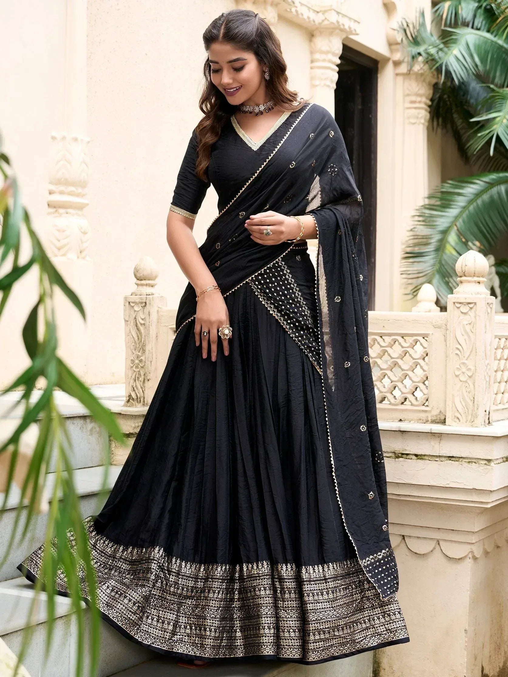 Black embroidered lehenga choli with gold detailing, perfect for Indian ethnic wear occasions