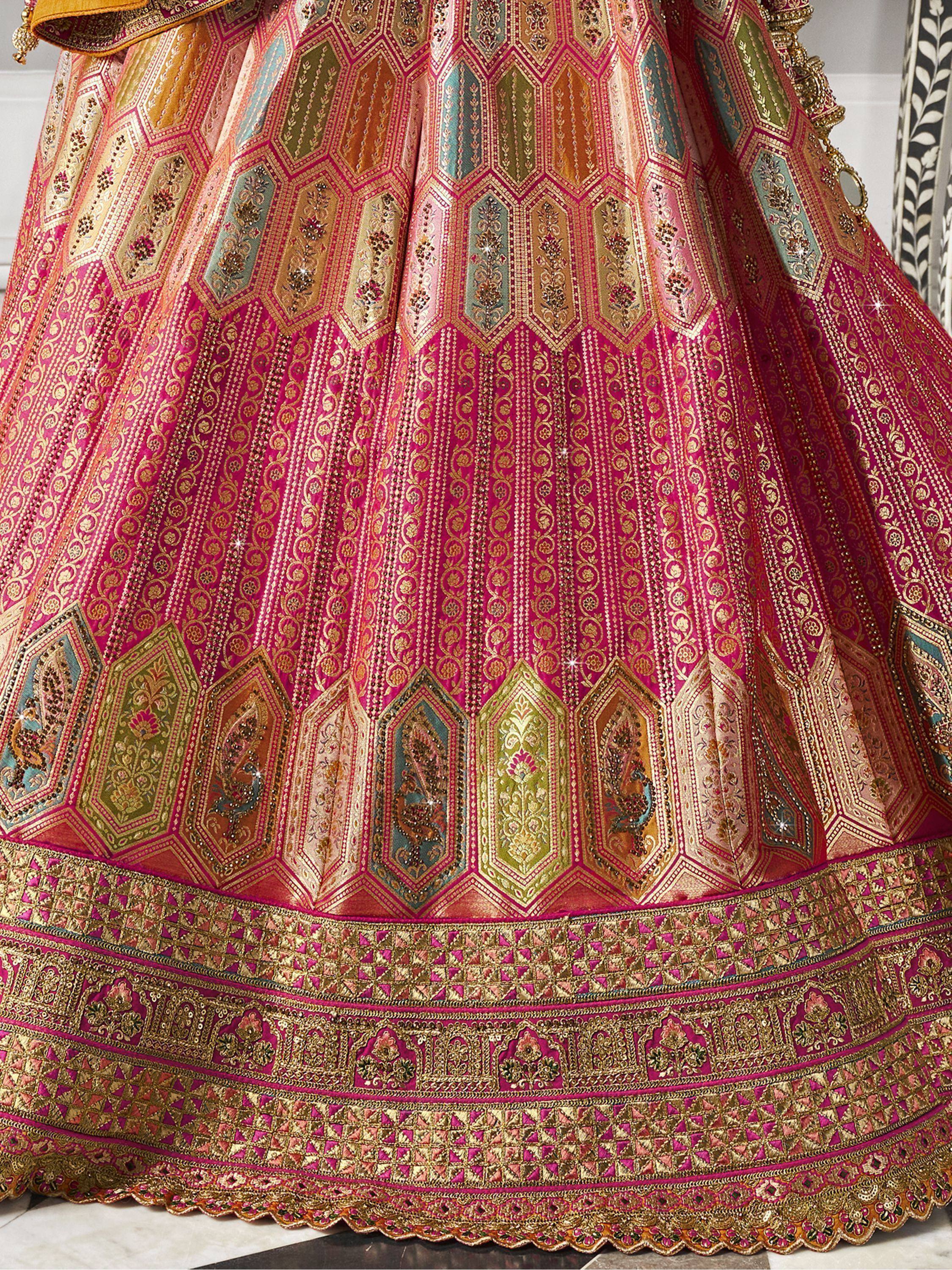 Pink and gold designer lehenga with intricate geometric and floral embroidery, perfect for Indian weddings.