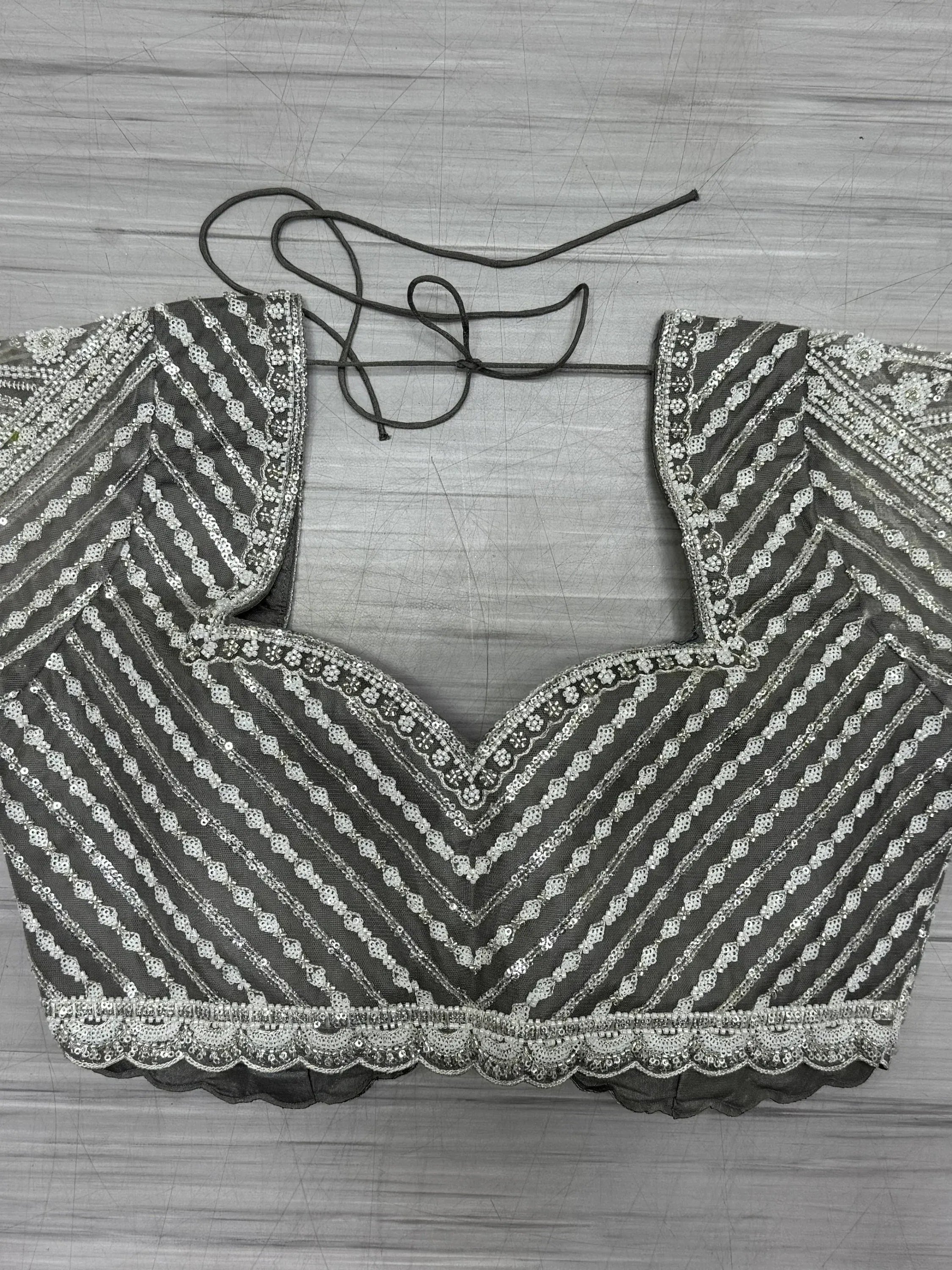 Grey embroidered lehenga choli blouse with silver sequins and scalloped hem, back tie detail