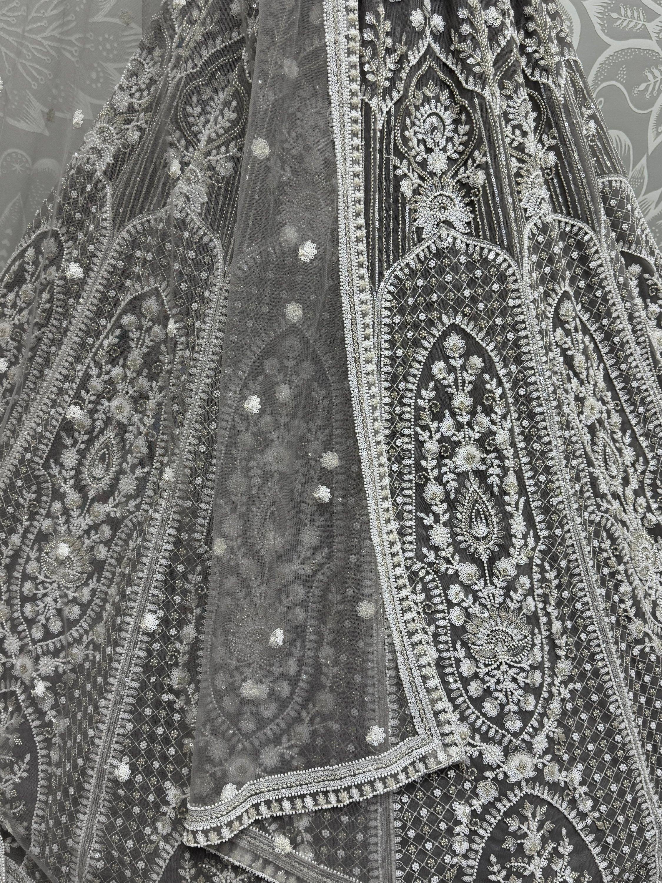 Grey designer lehenga with intricate silver embroidery and beadwork, perfect for Indian ethnic wear.