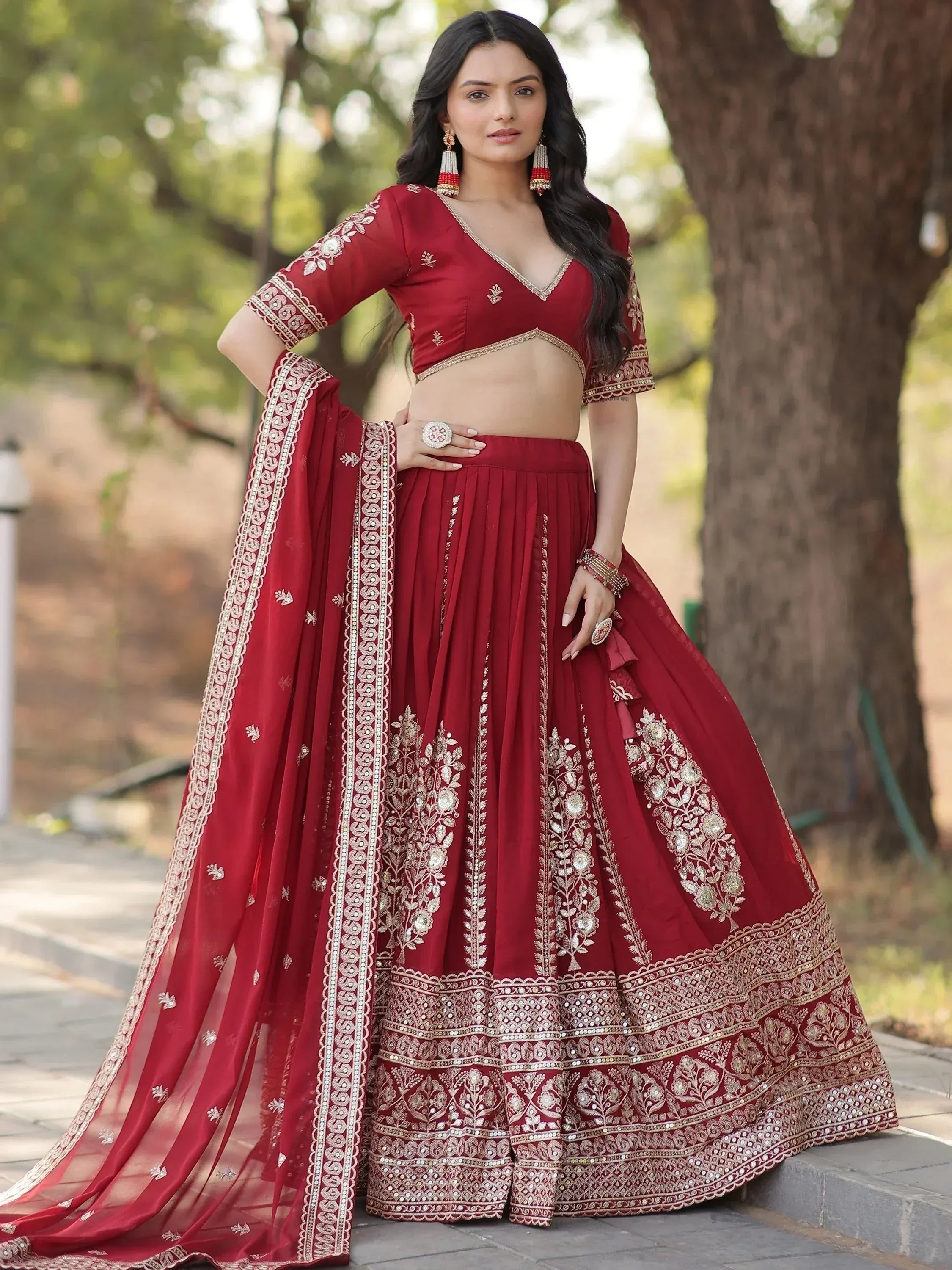 Red embroidered lehenga choli with gold detailing, perfect for Indian weddings and festive occasions