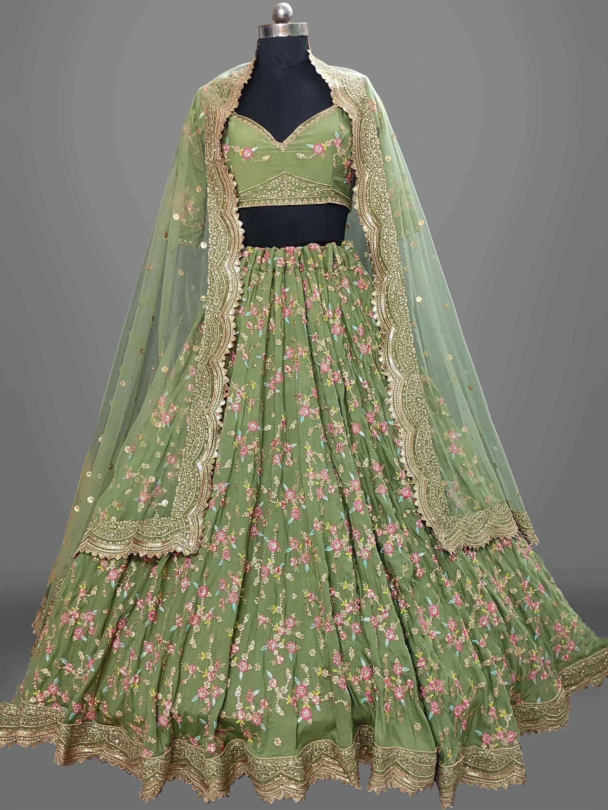 Green floral embroidered lehenga choli with gold detailing and sheer dupatta, Indian ethnic wear