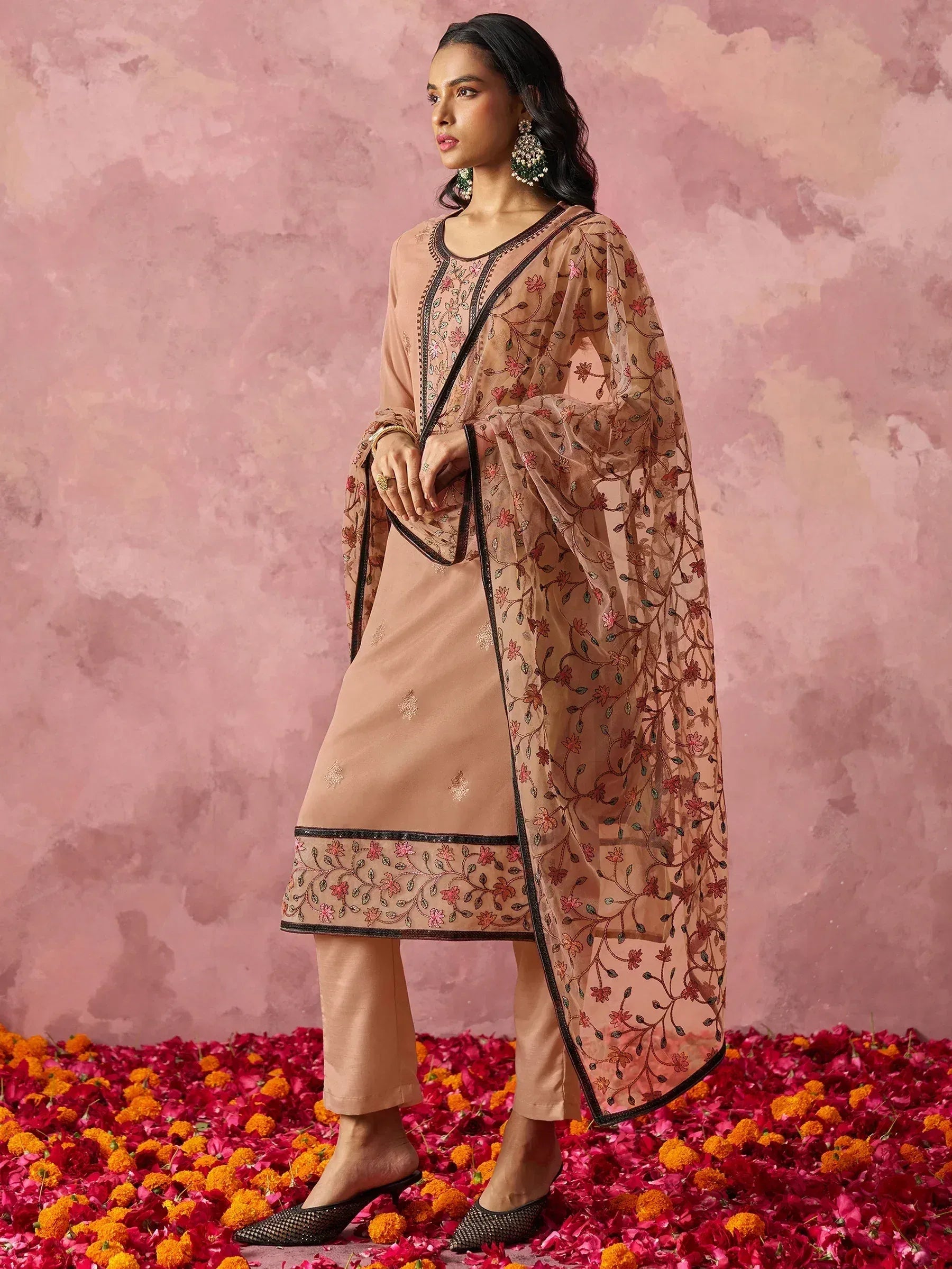 Elegant peach salwar kameez with floral embroidery and sheer dupatta, perfect for ethnic occasions.