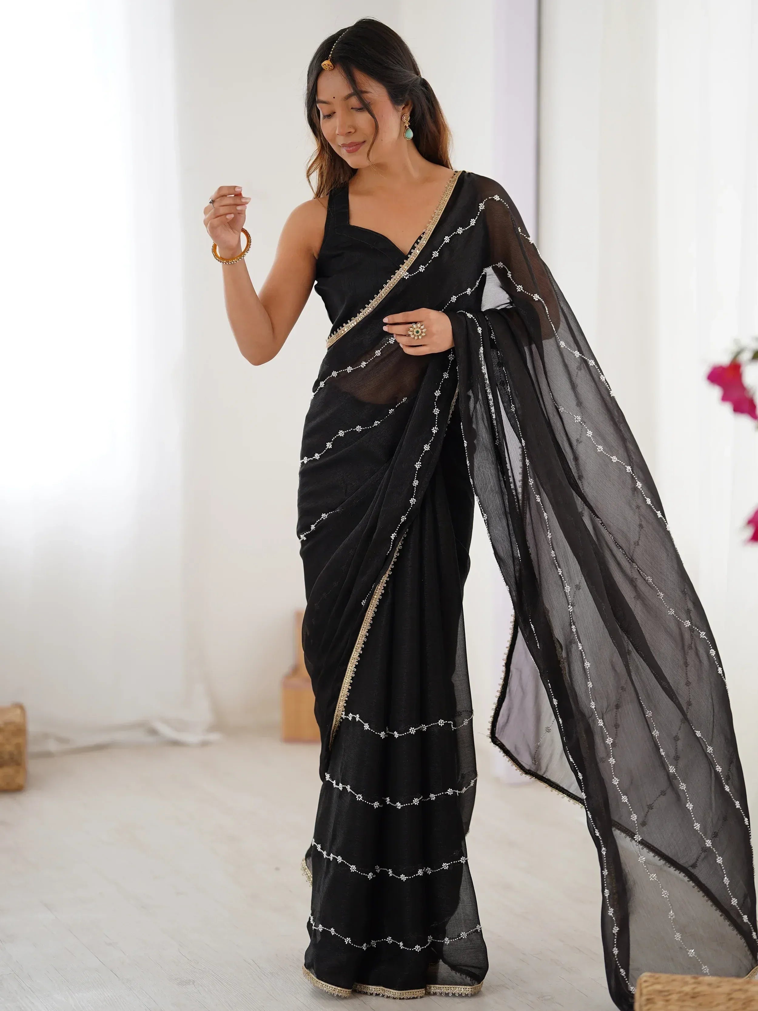 Black embroidered saree with gold trim, stylish Indian ethnic wear for women