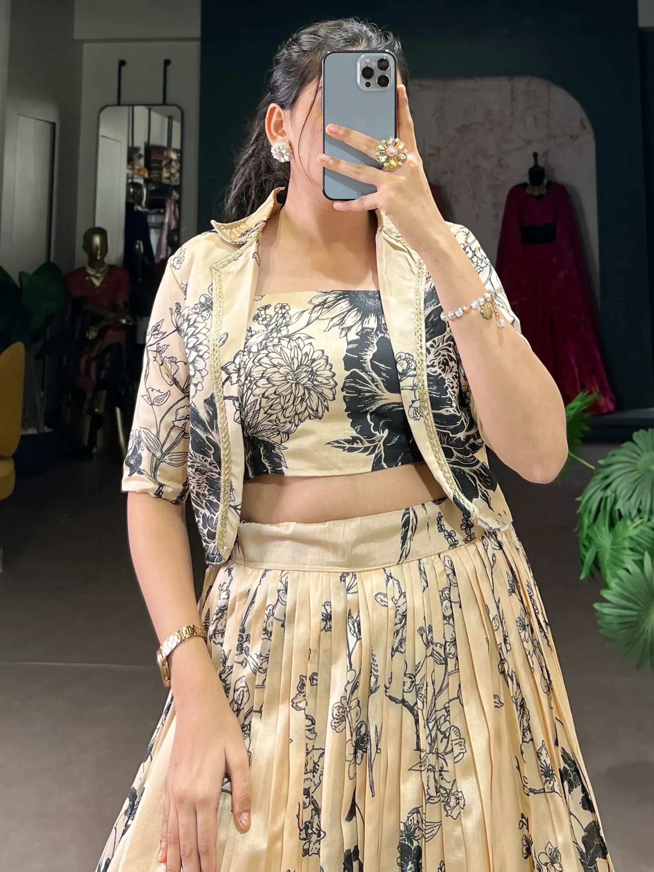 Beige floral lehenga choli with gold trim, styled with matching jacket for ethnic wear