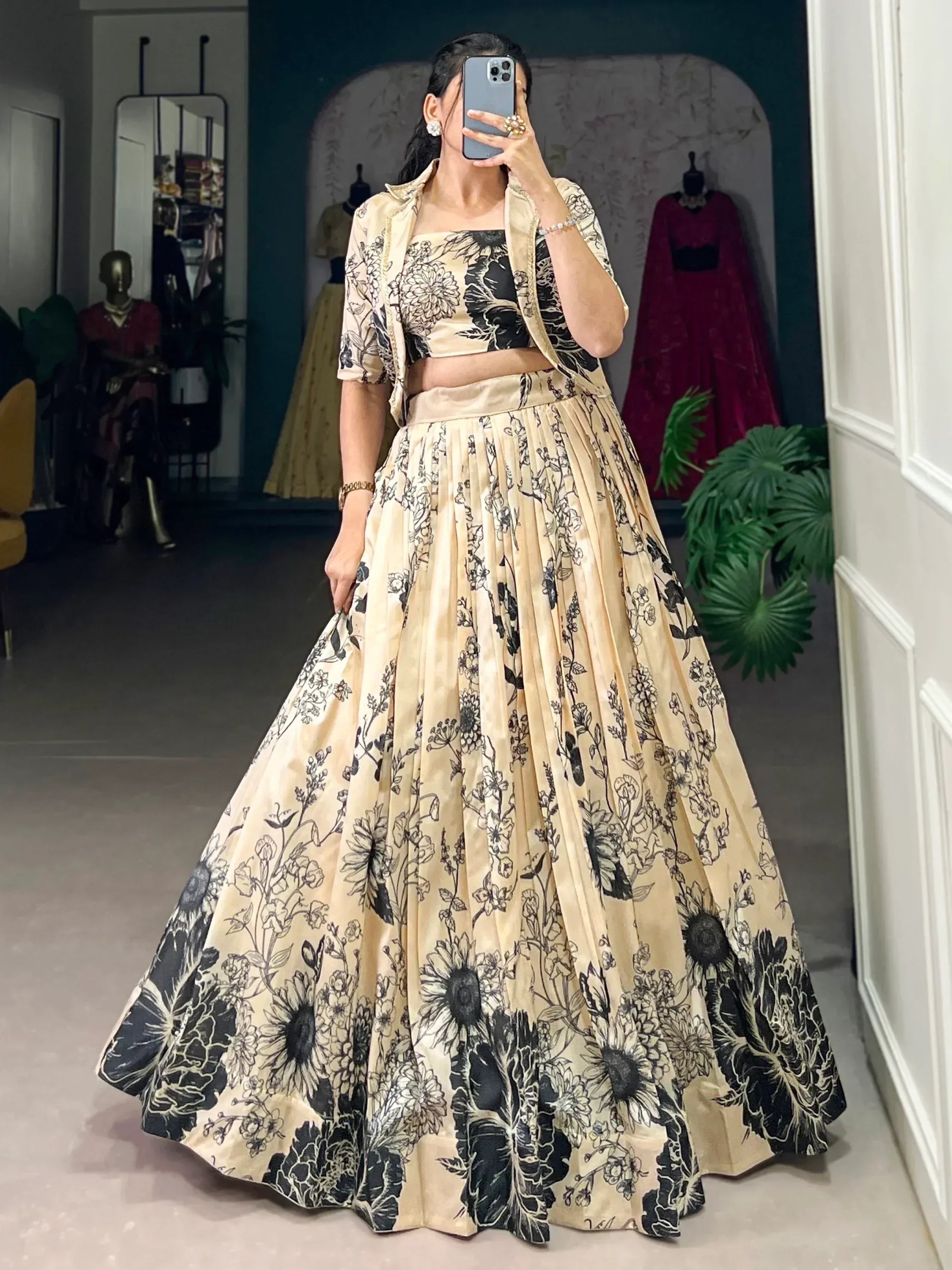 Cream and black floral print lehenga choli with matching jacket, perfect for Indian ethnic wear occasions.