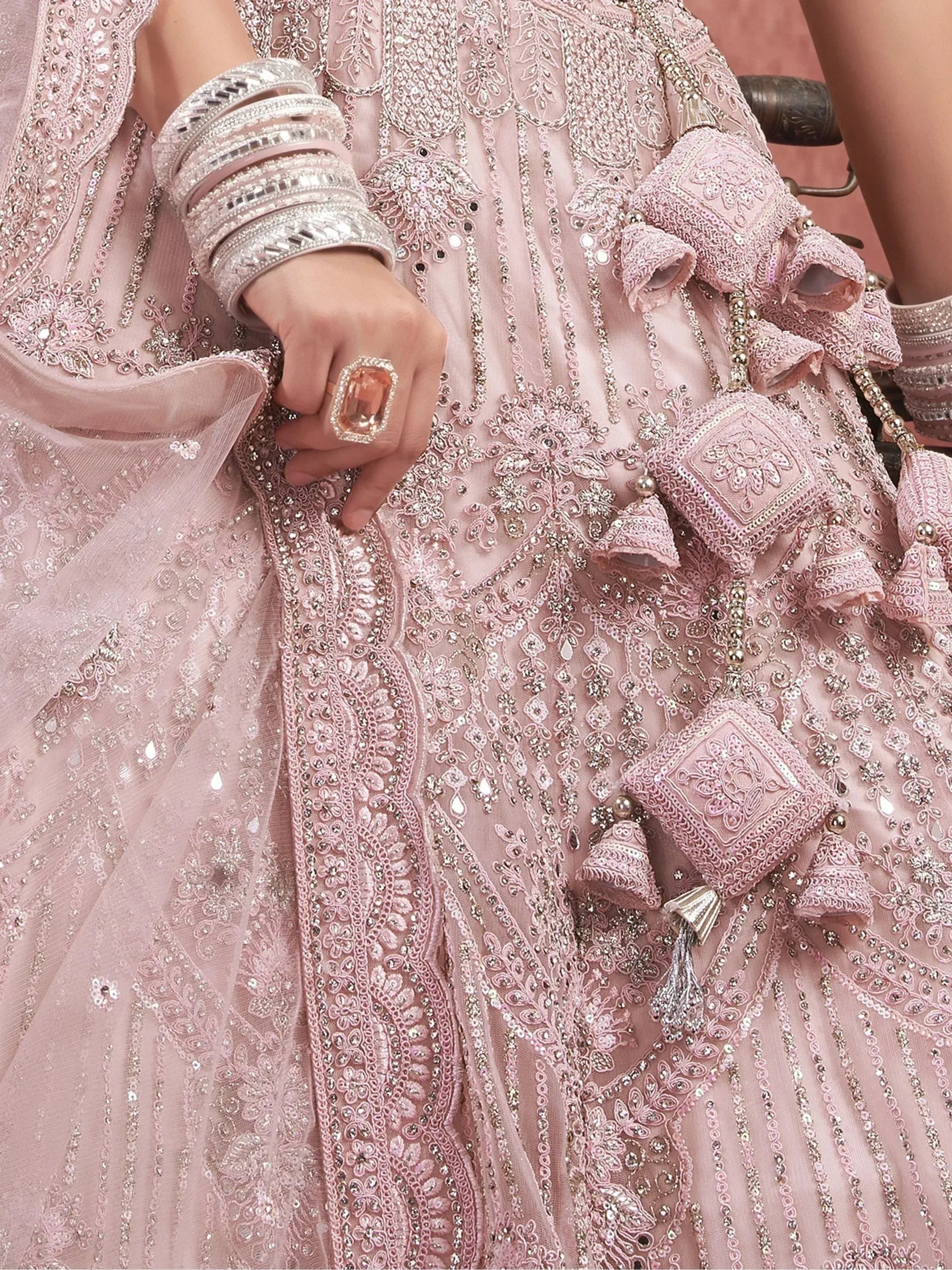 Pink embroidered lehenga choli with sequins, bangles, and statement ring for Indian ethnic wear