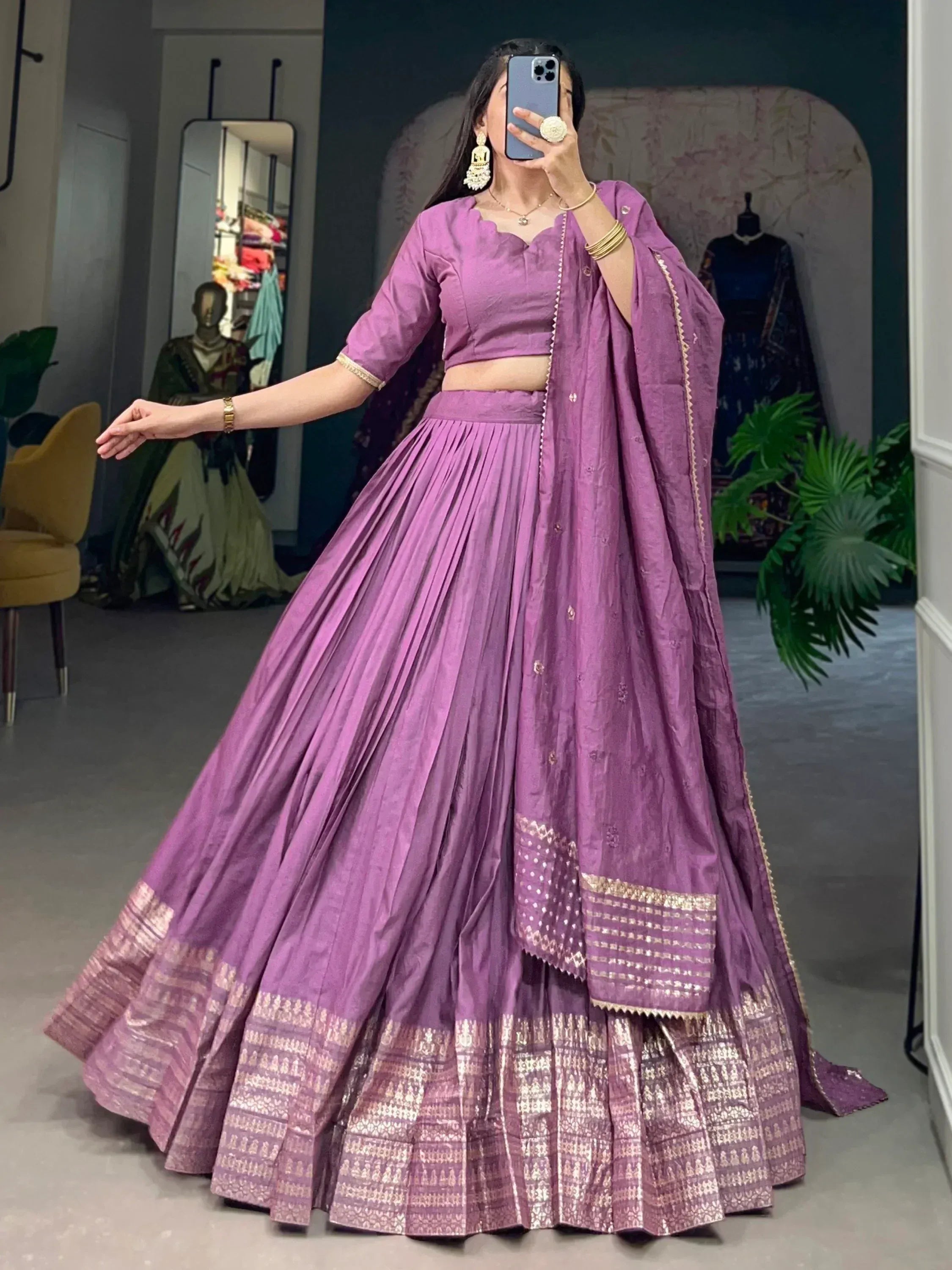 Purple lehenga choli with gold border, pleated skirt, and matching dupatta for Indian ethnic wear