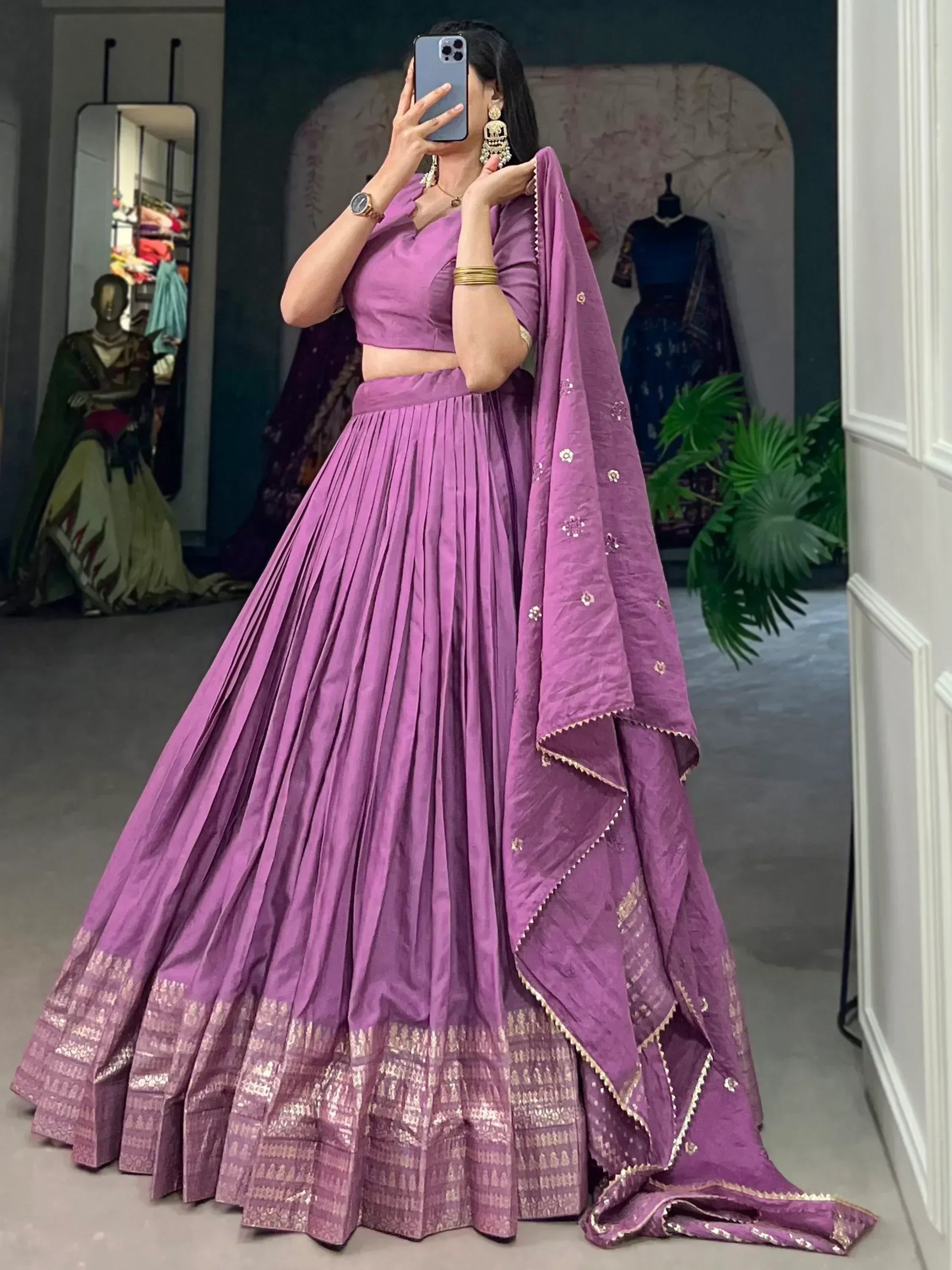 Purple designer lehenga choli with pleated skirt and embroidered dupatta, perfect for Indian ethnic wear occasions.