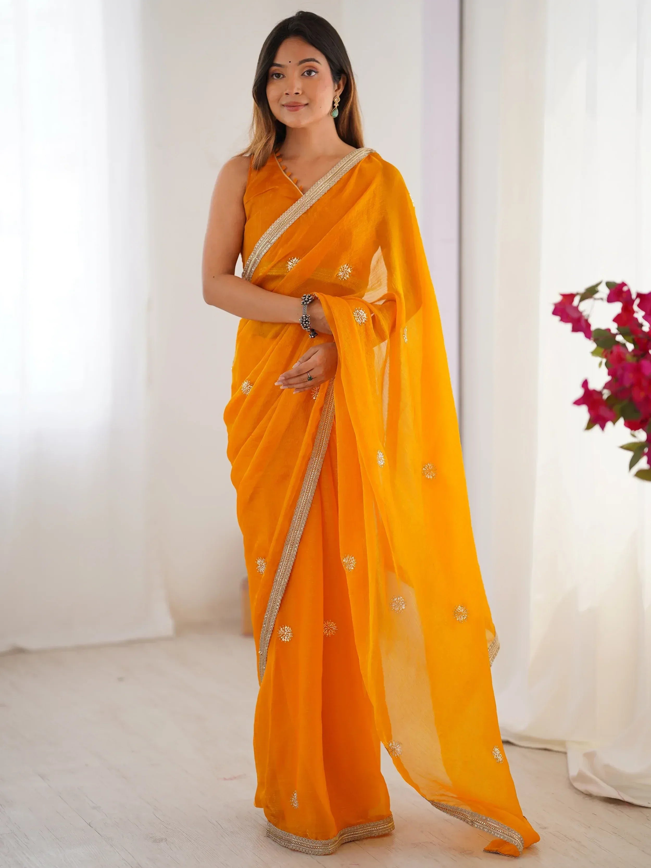 Vibrant orange saree with gold embroidery and border, perfect for Indian ethnic wear occasions