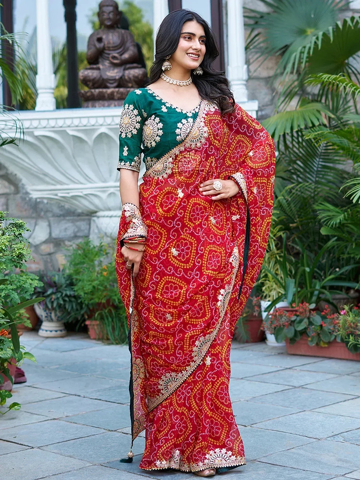 Woman in red printed saree with green embroidered blouse, ethnic Indian wear for festive occasions