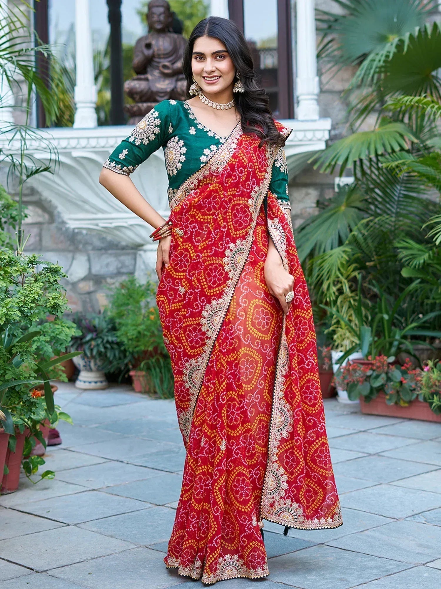 Woman in red printed saree with green embroidered blouse, ethnic Indian wear for festive occasions
