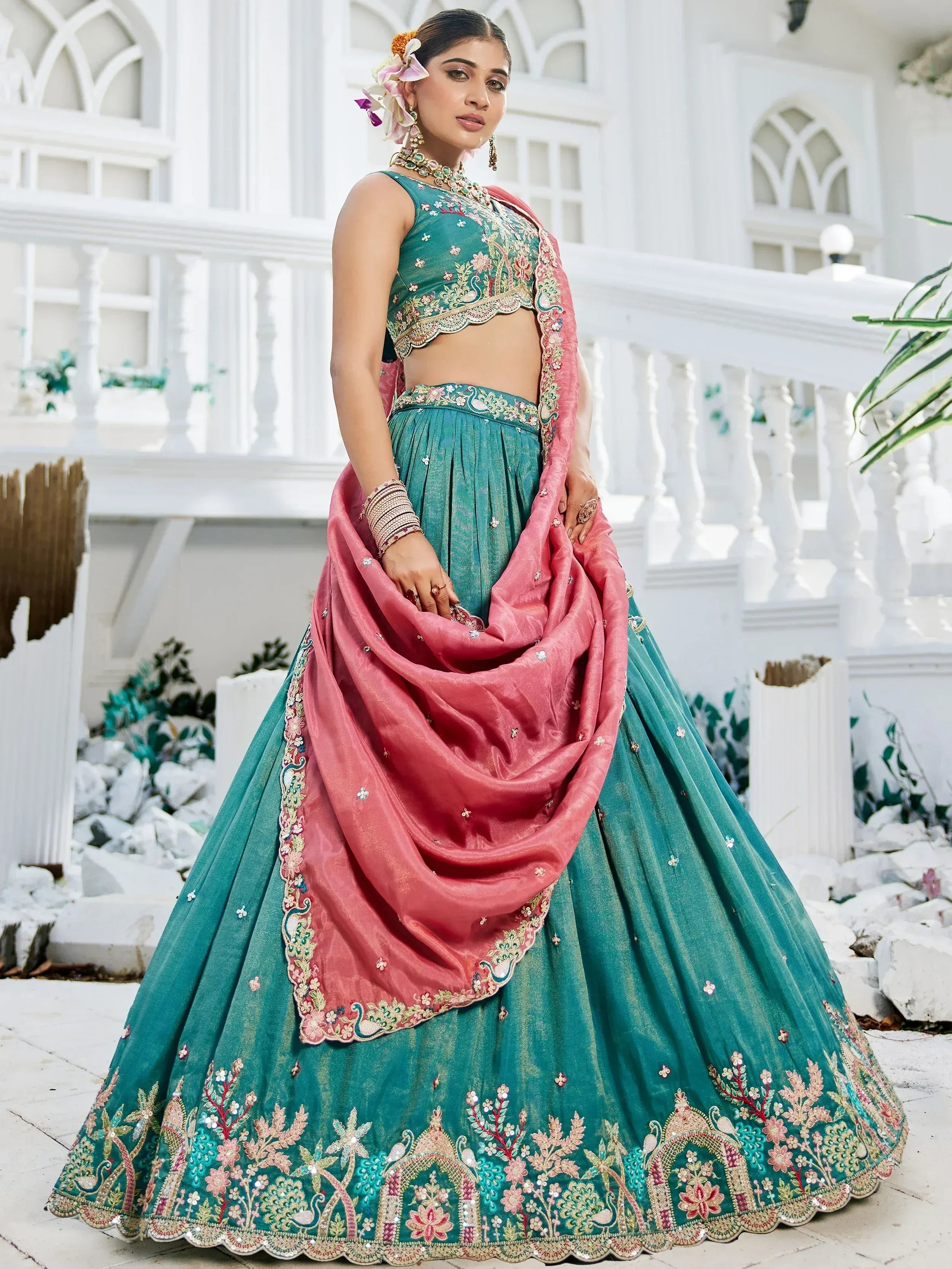 Teal embroidered lehenga choli with pink dupatta, floral embellishments, perfect for Indian weddings and festivals