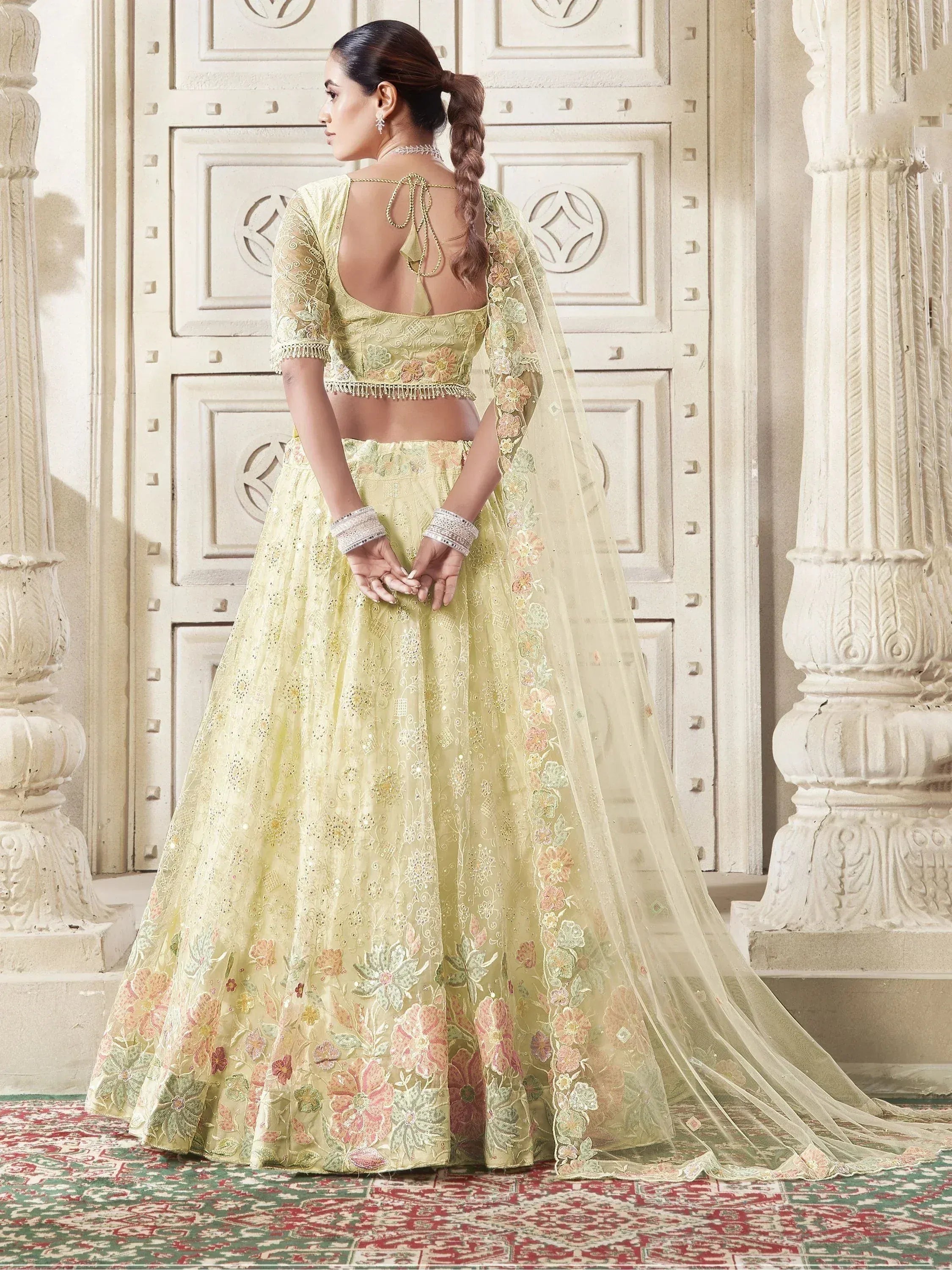 Elegant light green lehenga choli with floral embroidery and sheer dupatta, perfect for Indian weddings and festive occasions.