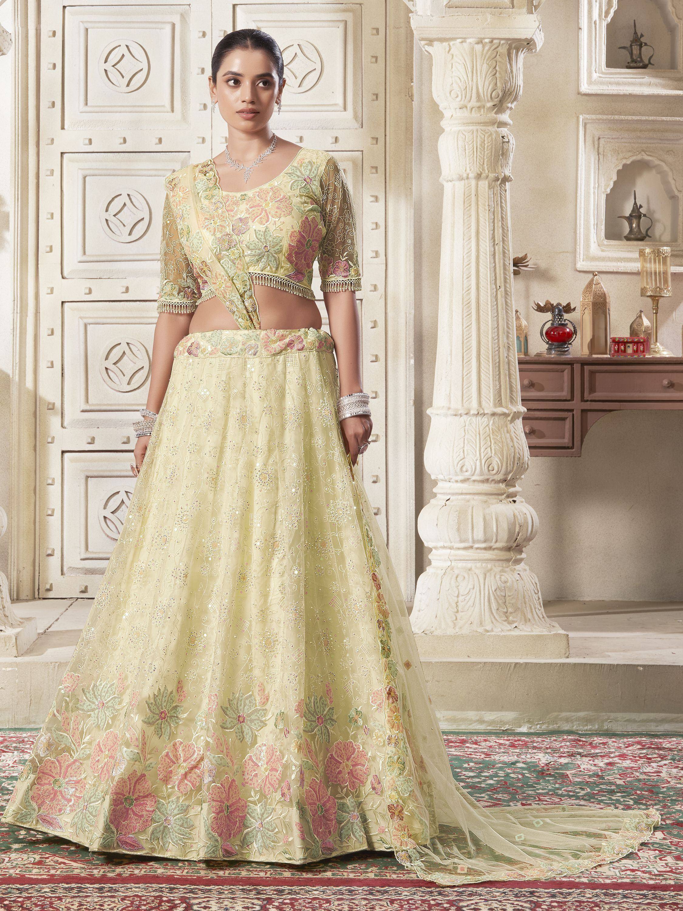 Elegant pastel yellow lehenga choli with floral embroidery, perfect for Indian weddings and festive occasions.