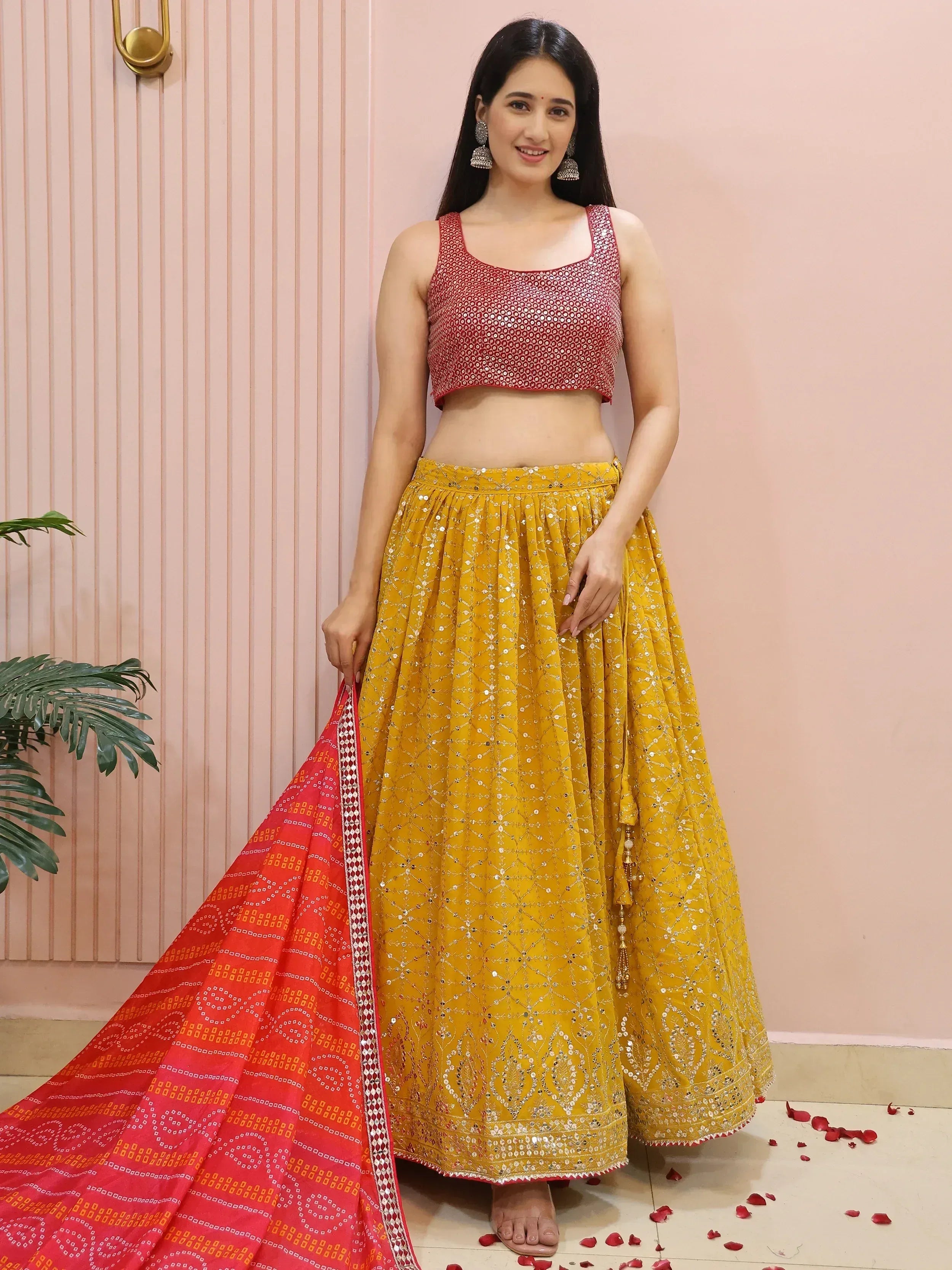 Yellow and red designer lehenga choli with mirror work, perfect for Indian ethnic wear occasions