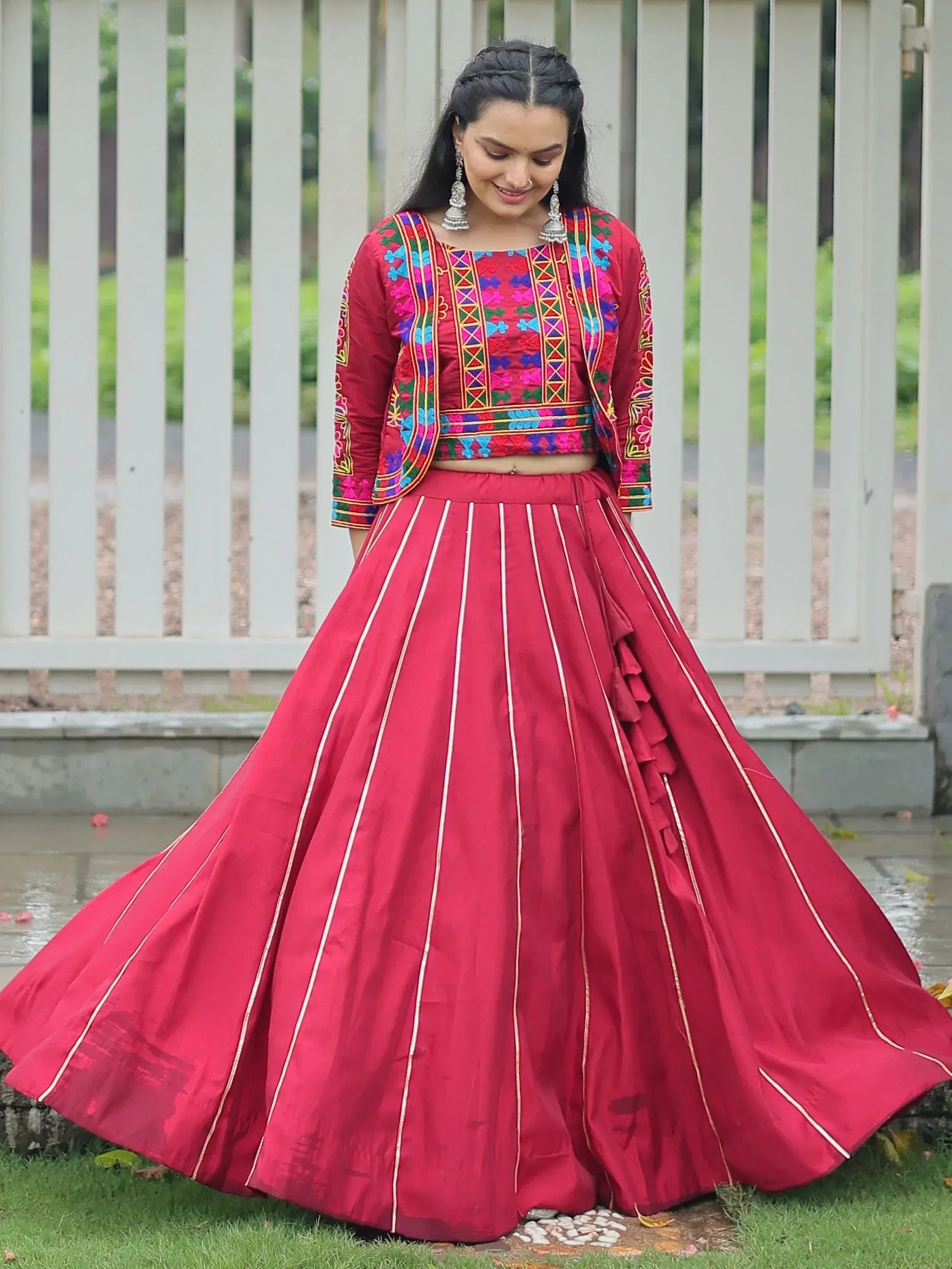 Vibrant red lehenga choli with colorful embroidery, perfect for Indian ethnic wear and festive occasions.