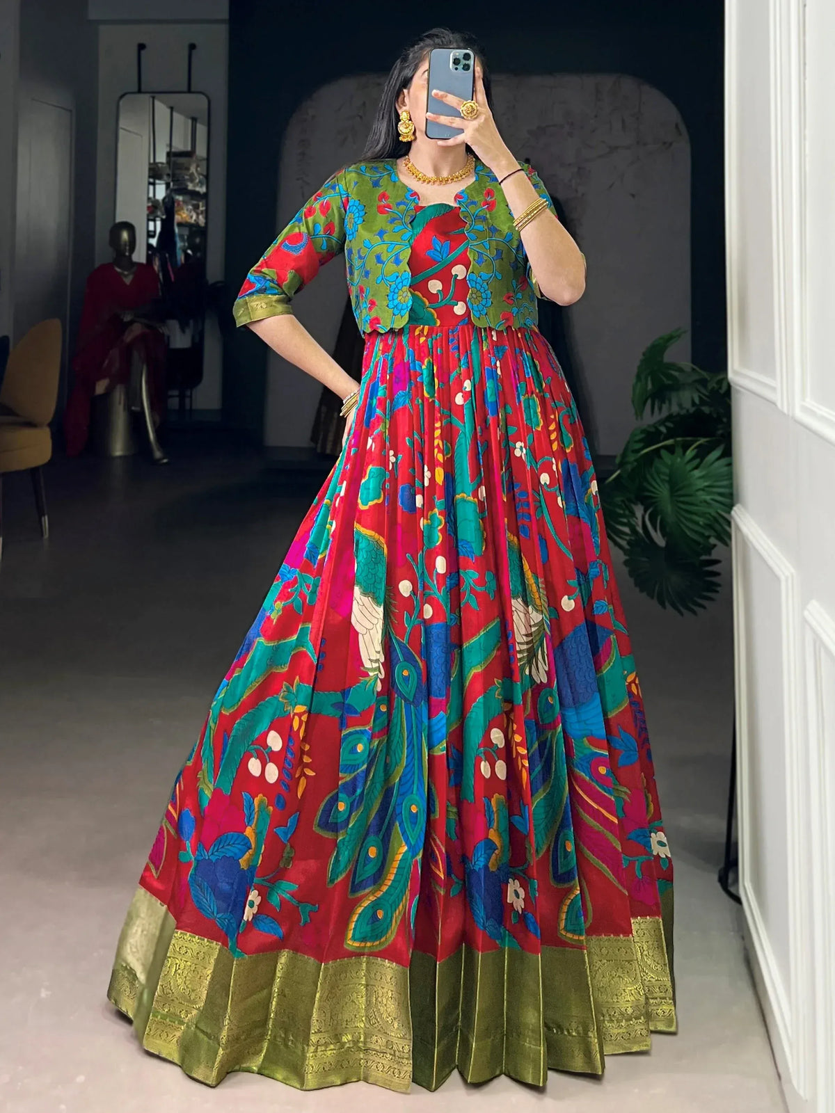 Vibrant red and green floral print ethnic gown with peacock motifs and gold border