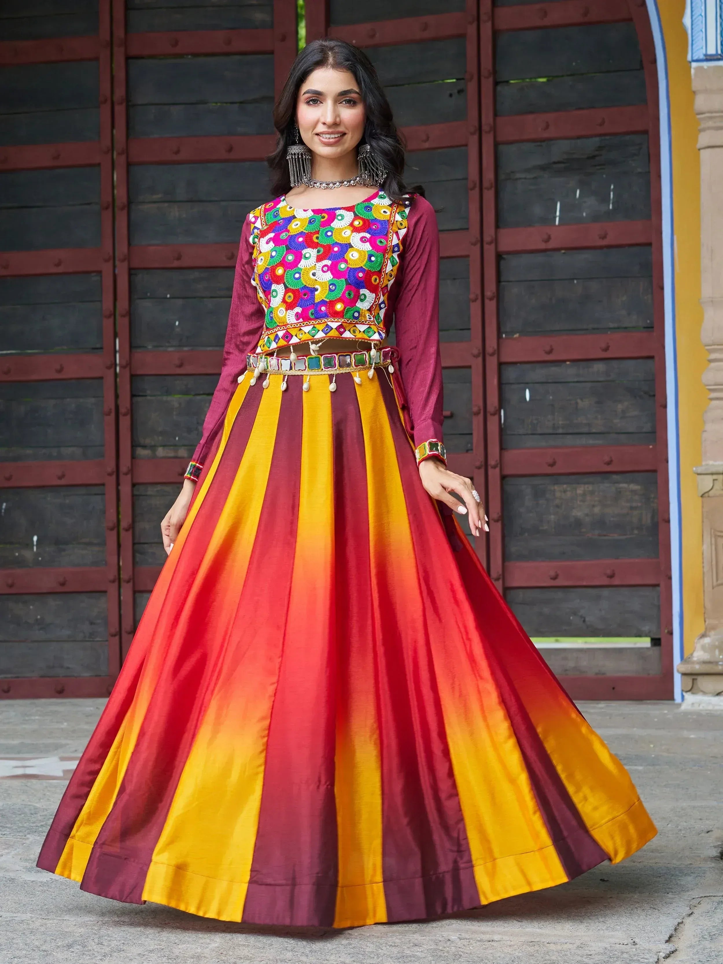 Vibrant Indian ethnic lehenga choli with colorful mirror work and striped skirt, perfect for festive occasions