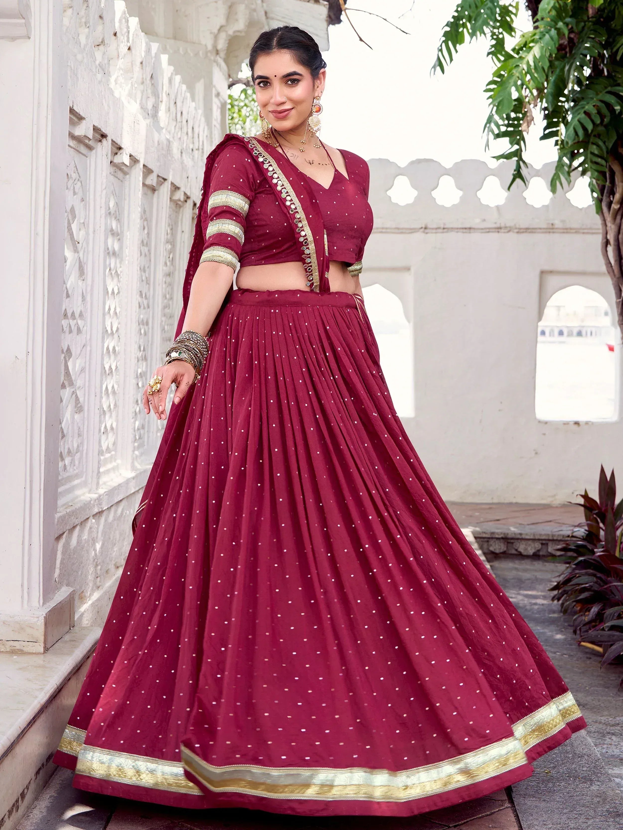 Maroon lehenga choli with gold trim and mirror work, perfect for Indian ethnic occasions