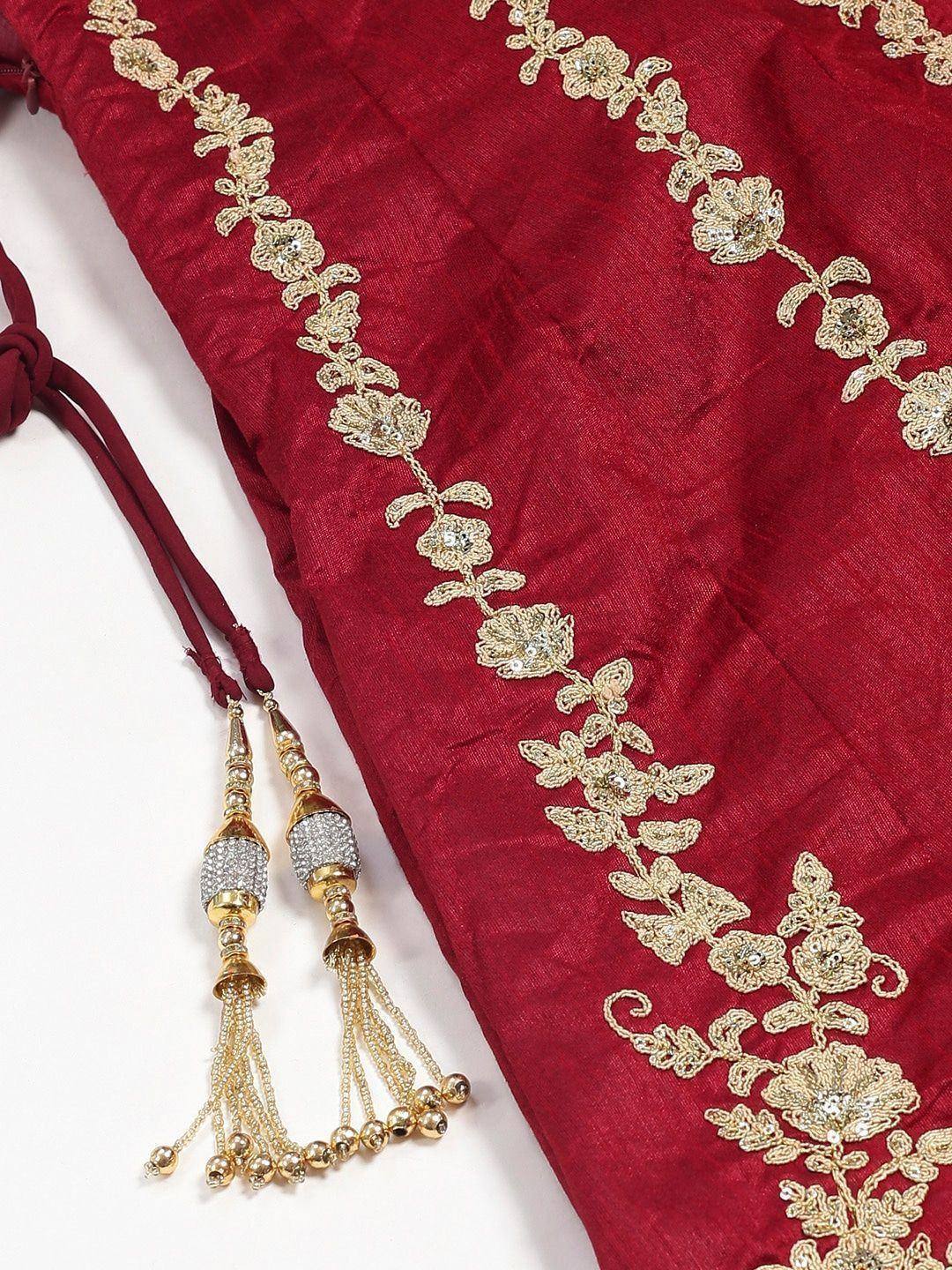 Red ethnic wear with gold floral embroidery and beaded tassels, perfect for festive occasions.