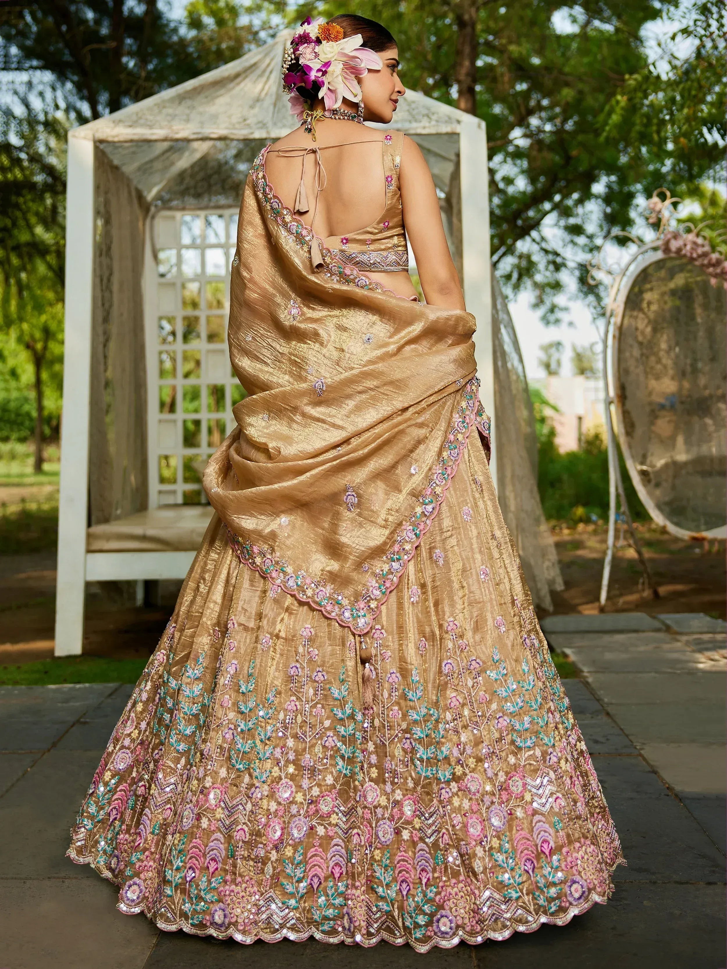 Gold embroidered lehenga choli with floral detailing, perfect for Indian weddings and festive occasions.