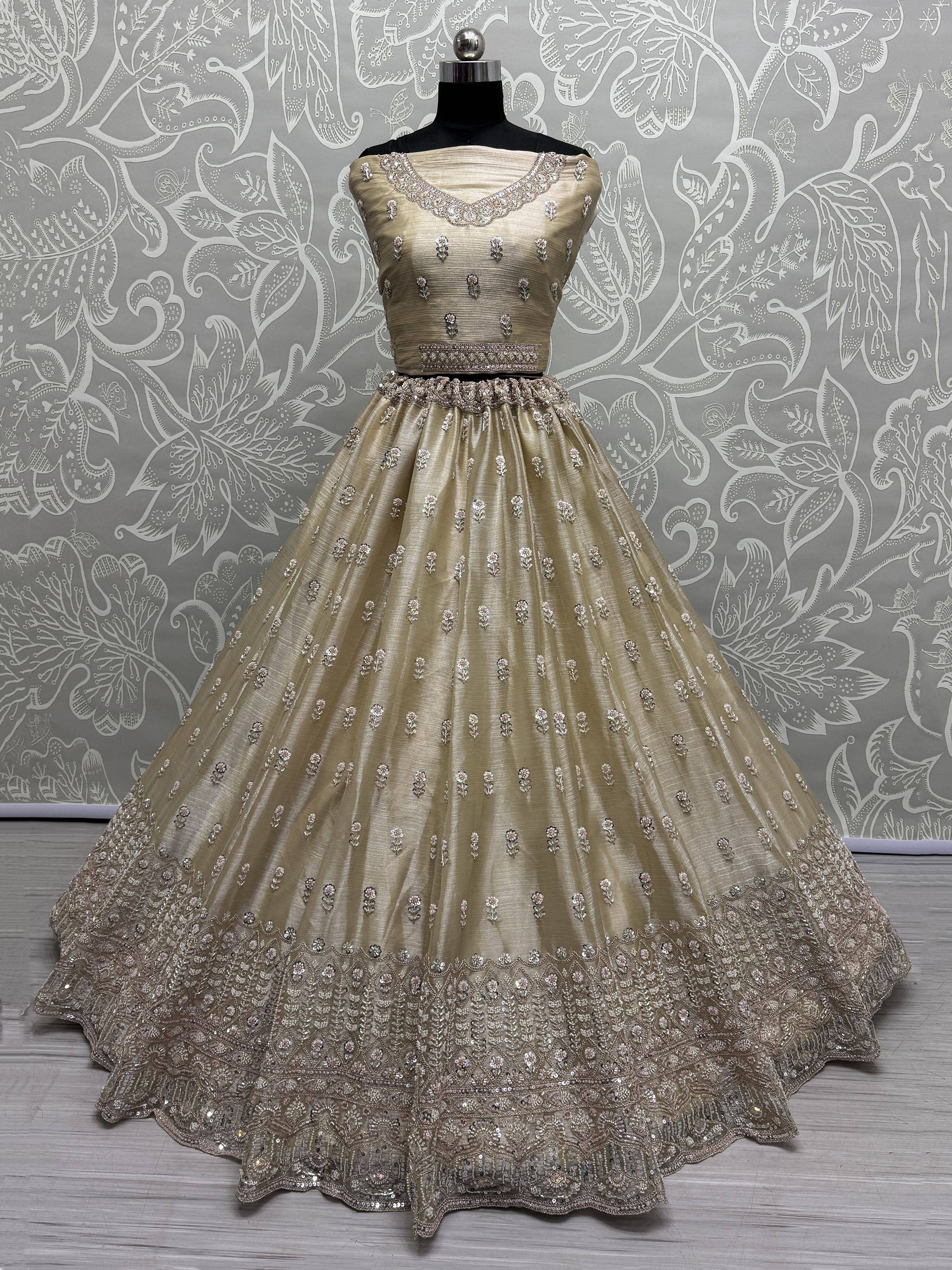 Beige designer lehenga choli with intricate embroidery and sequin work, perfect for Indian ethnic occasions.