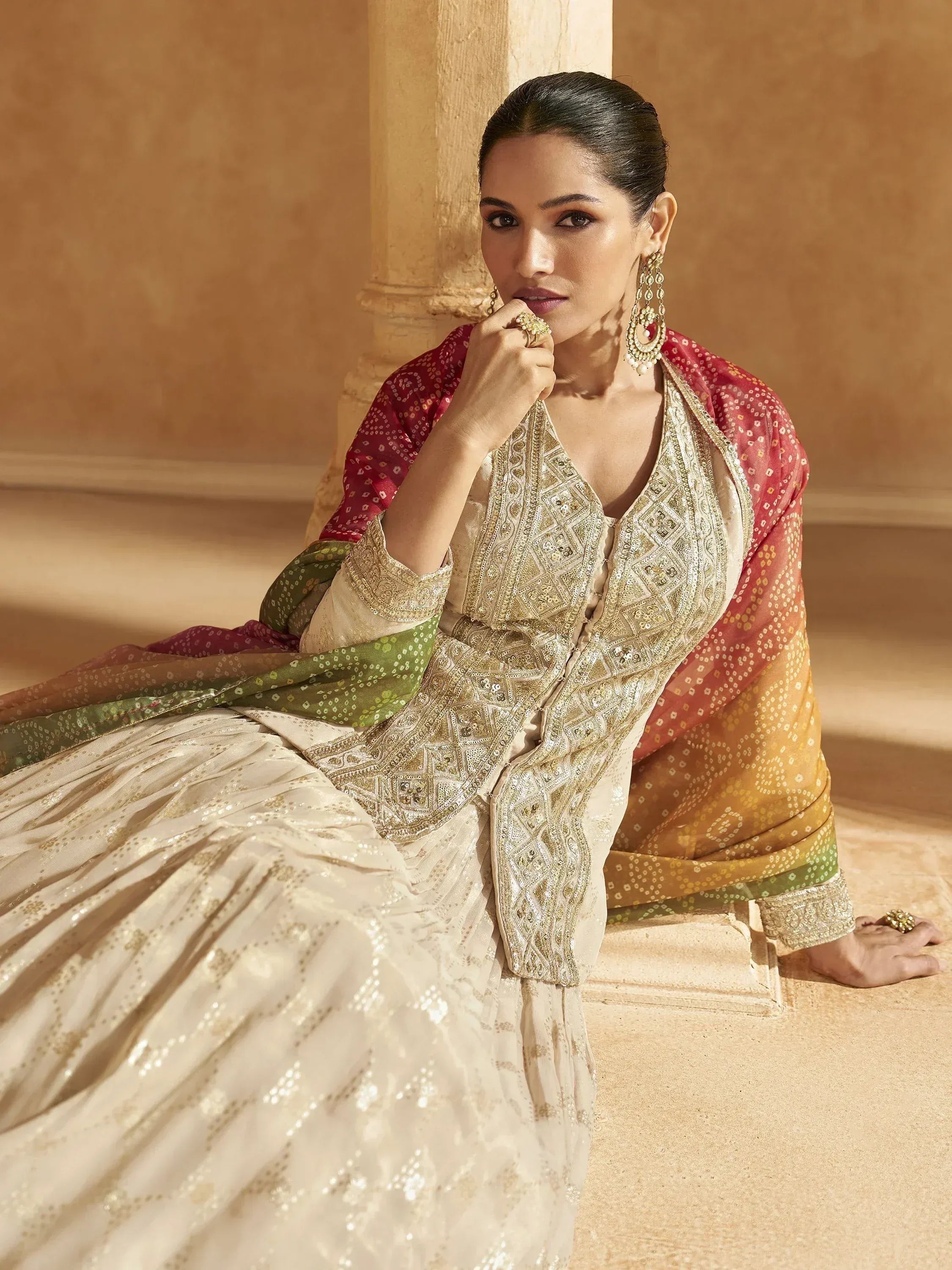 Elegant woman in cream embroidered lehenga choli with colorful dupatta, perfect for Indian ethnic wear occasions.