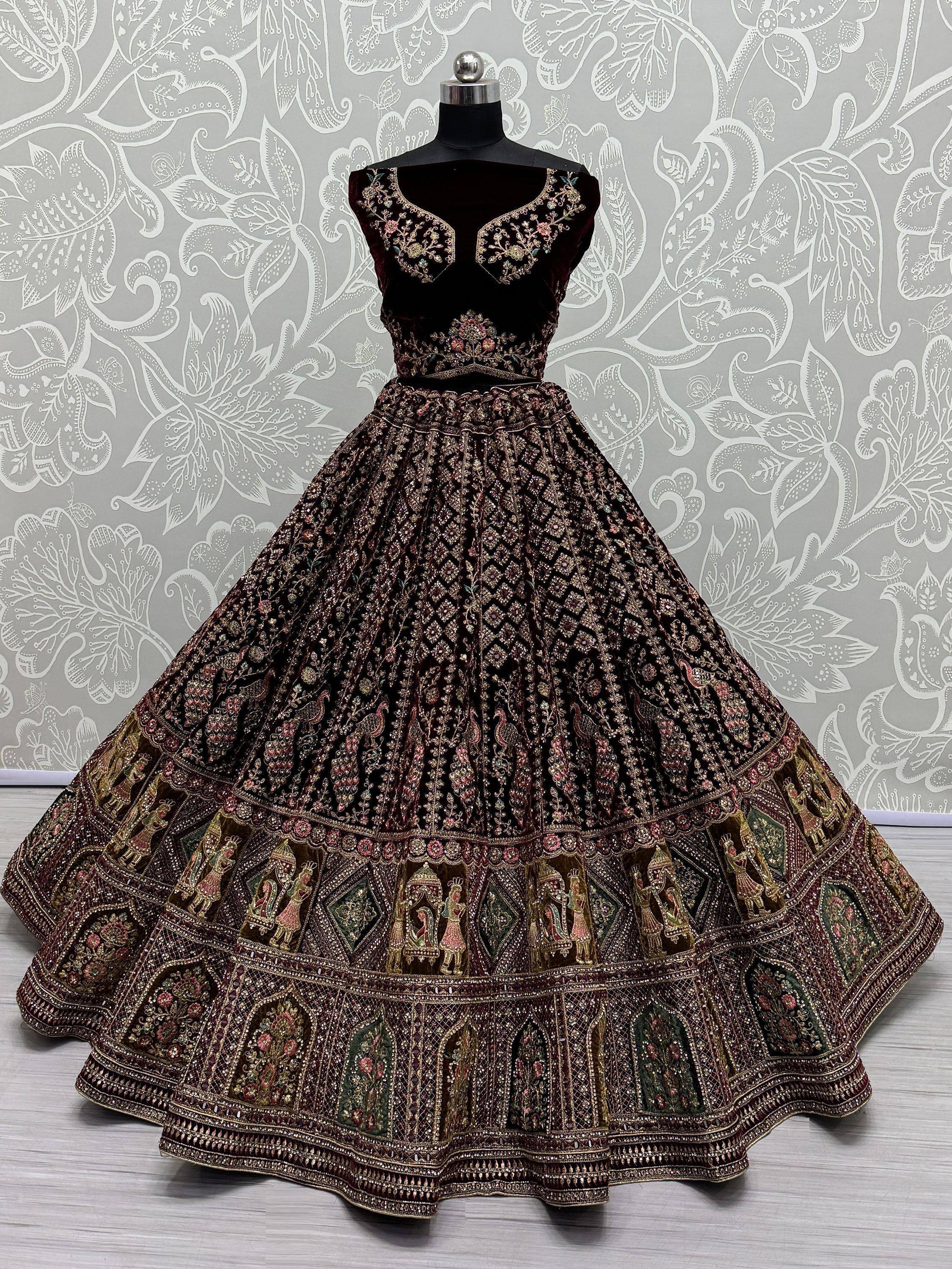 Designer maroon velvet lehenga choli with heavy embroidery and peacock motifs, perfect for weddings.