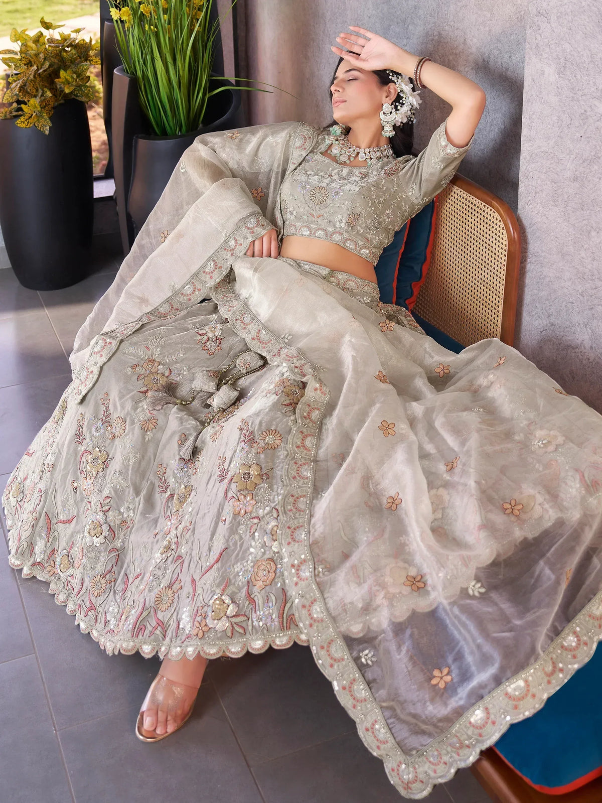 Elegant beige embroidered lehenga choli with floral motifs, perfect for Indian weddings and festive occasions.