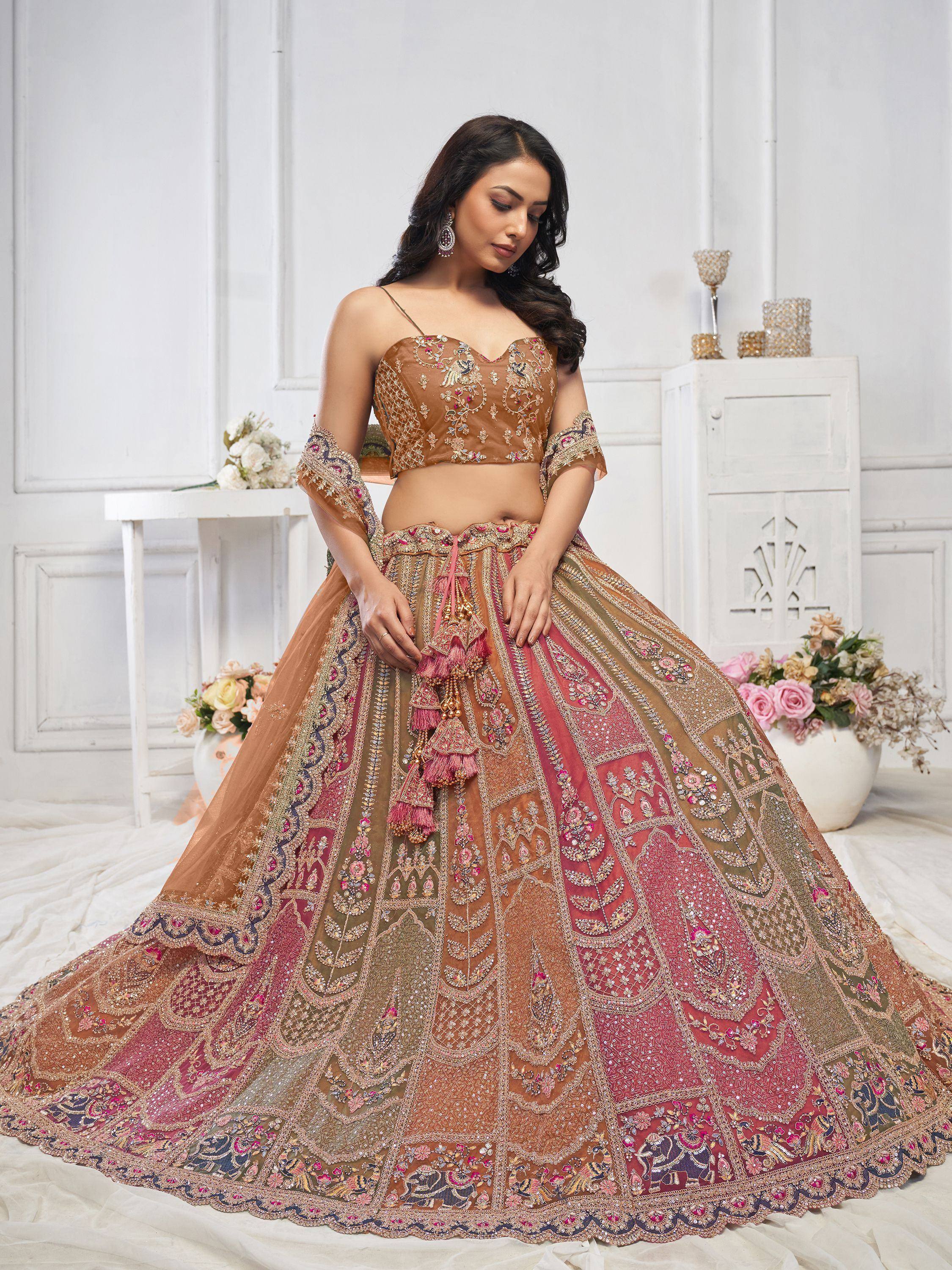 Designer lehenga choli with intricate embroidery and tassels, perfect for Indian weddings and festive occasions.