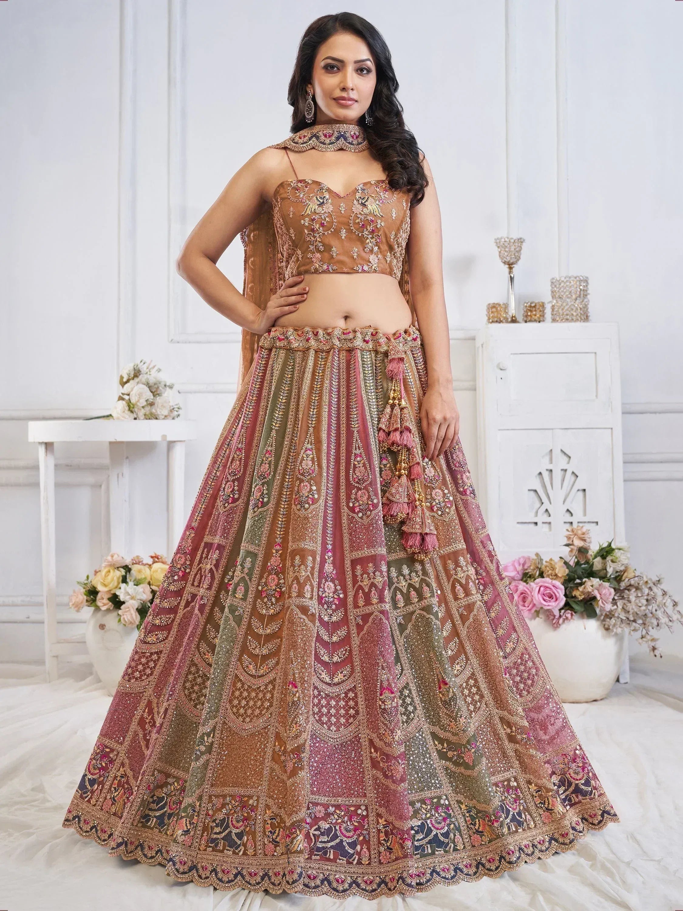 Elegant Indian lehenga choli with intricate embroidery and tassels, perfect for weddings and festive occasions.
