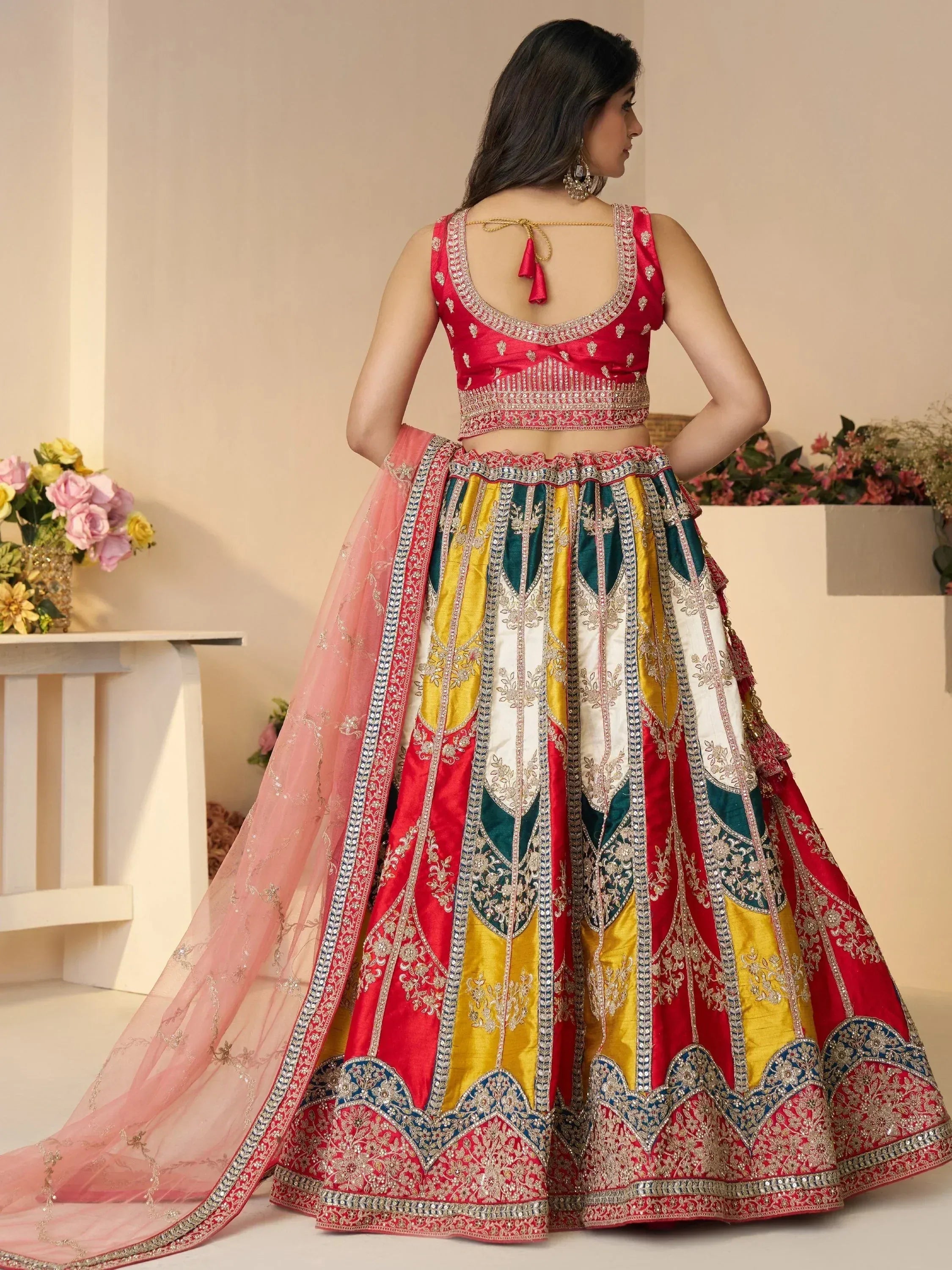 Designer lehenga choli with colorful patchwork, embroidery, and pink dupatta for Indian ethnic wear