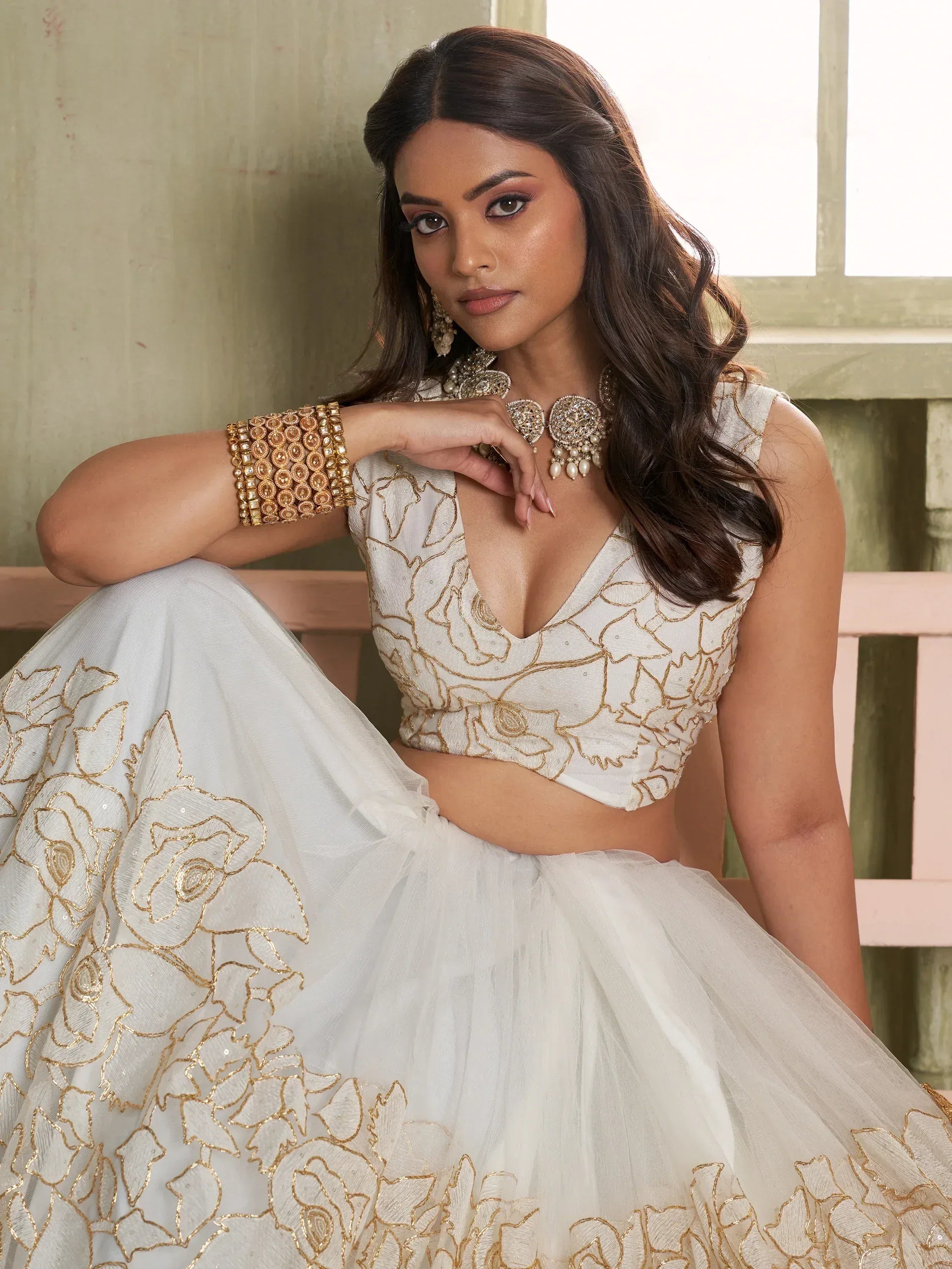 White and gold embroidered lehenga choli with floral design, perfect for Indian ethnic wear occasions.