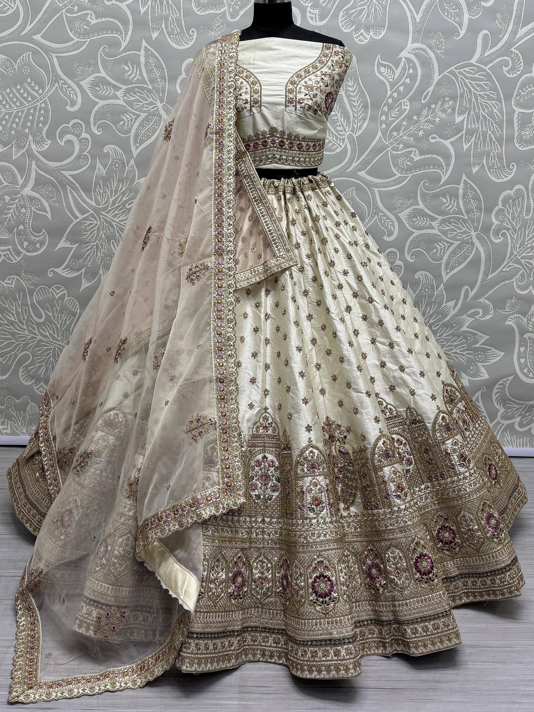Ivory designer lehenga choli with heavy floral embroidery and matching dupatta, perfect for weddings and festive occasions.