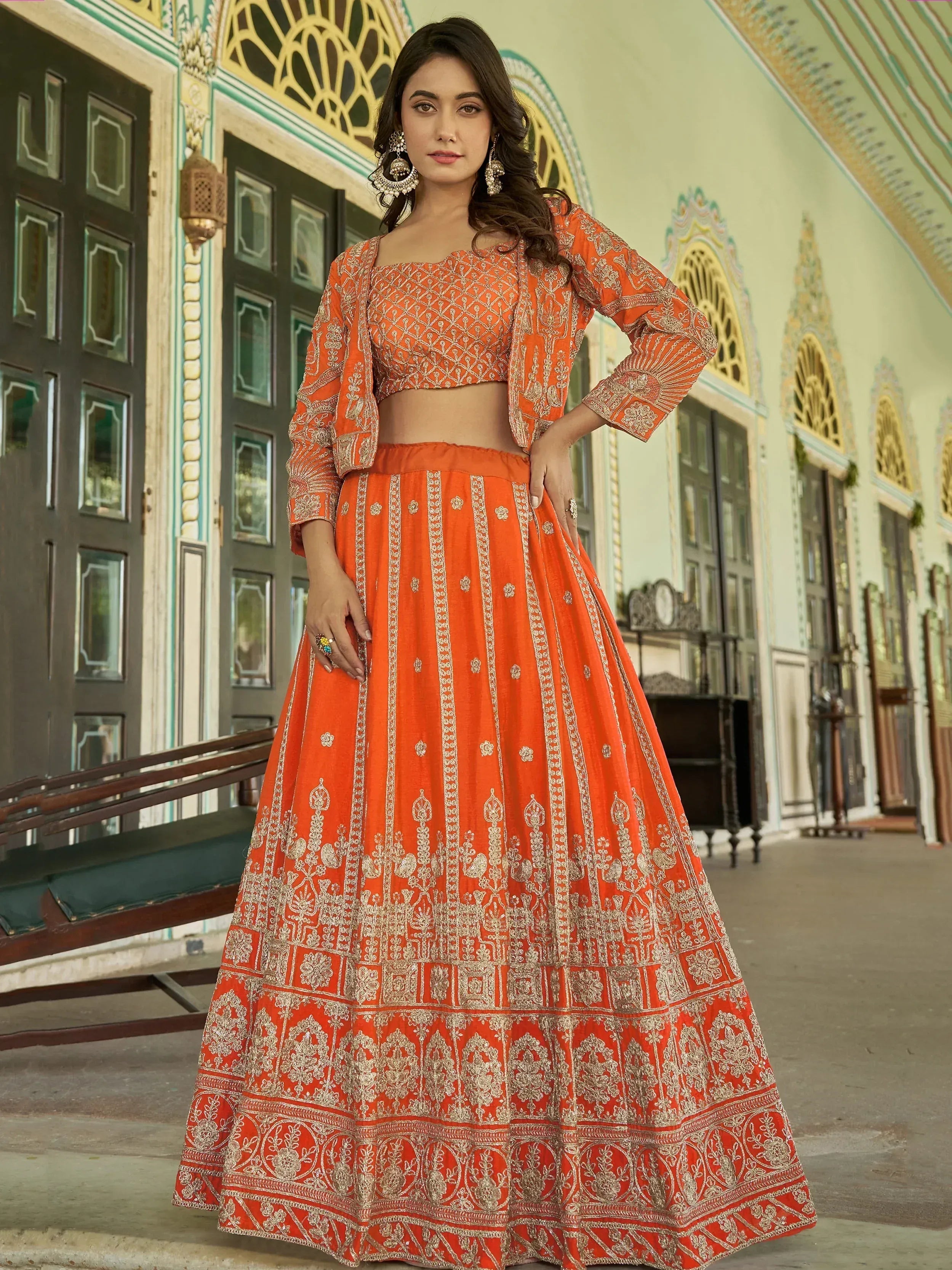 Orange embroidered lehenga choli with gold detailing, perfect for Indian ethnic occasions