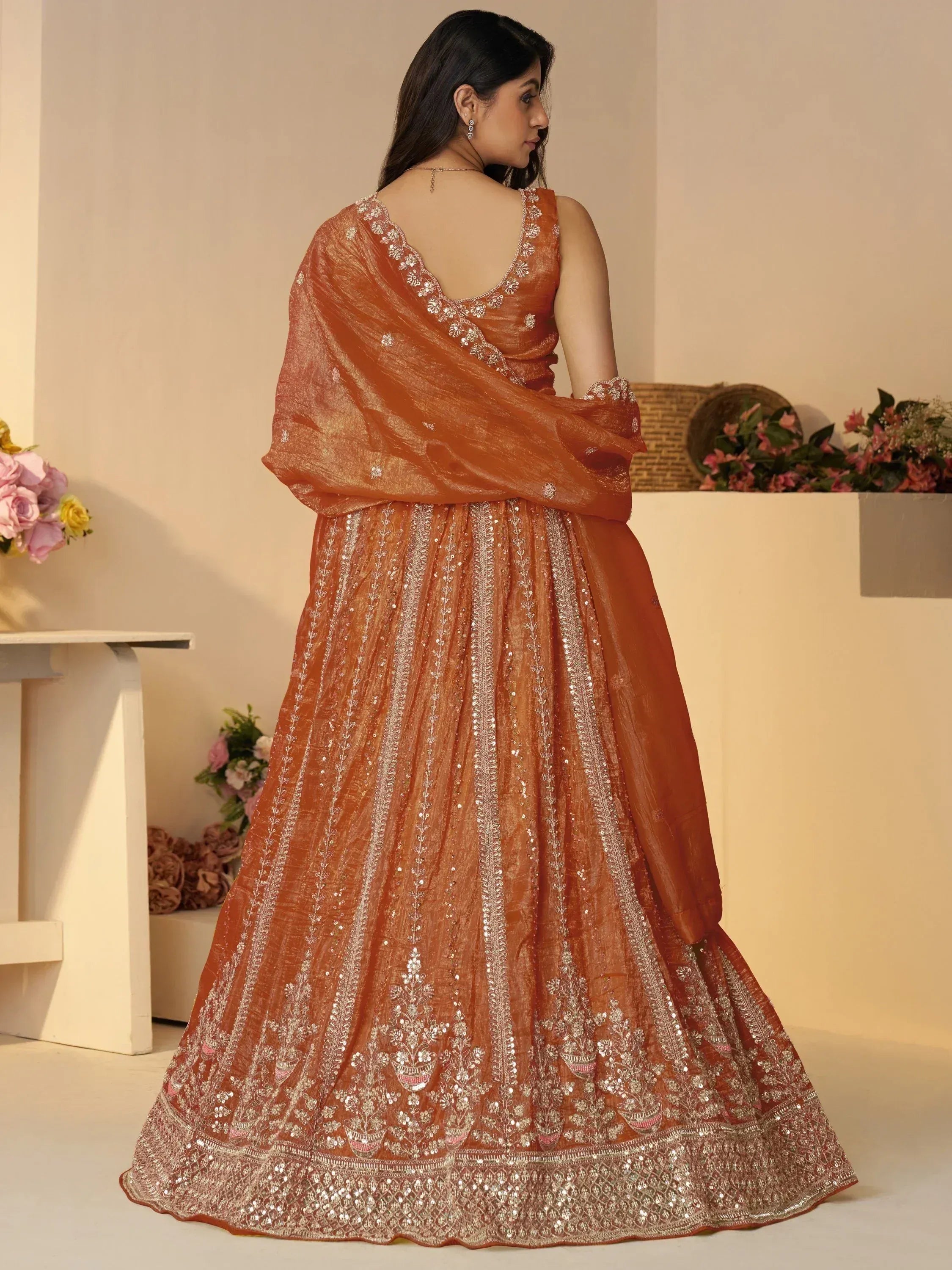 Orange designer lehenga choli with silver embroidery and sequins, perfect for Indian ethnic wear occasions