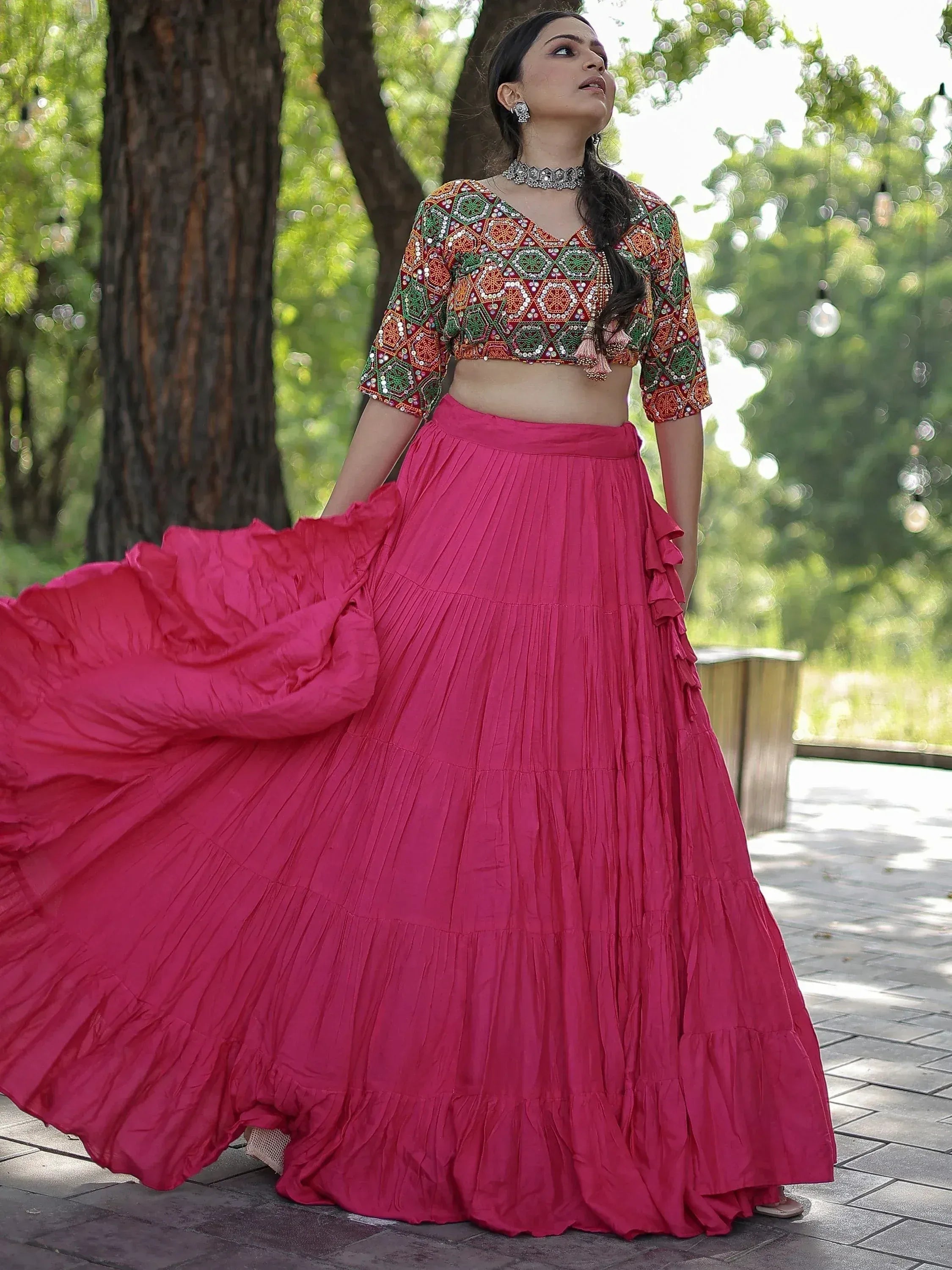 Woman in vibrant pink lehenga with embroidered crop top, perfect for Indian ethnic wear events