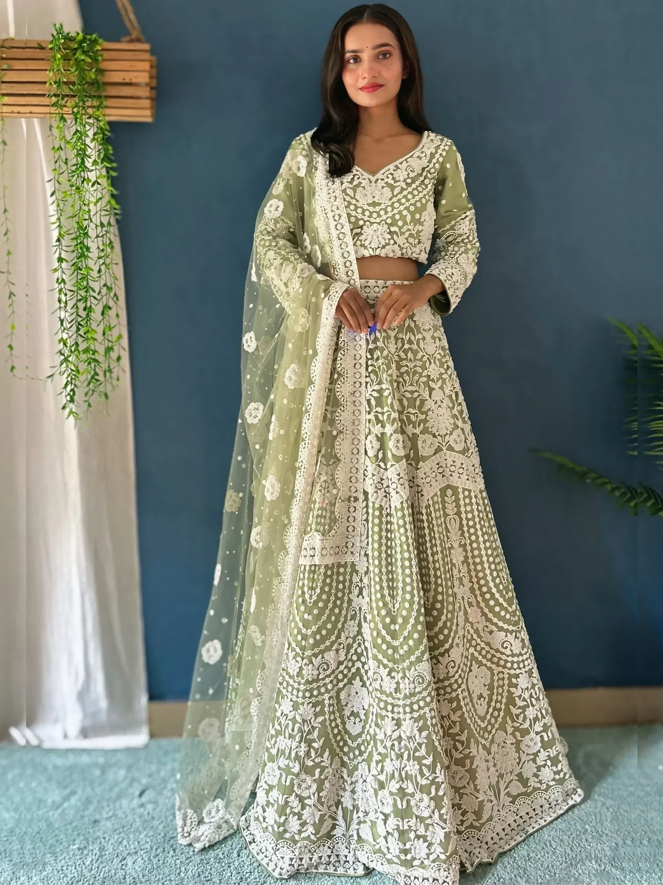Olive green designer lehenga choli with white floral embroidery and sheer dupatta, perfect for Indian ethnic wear.