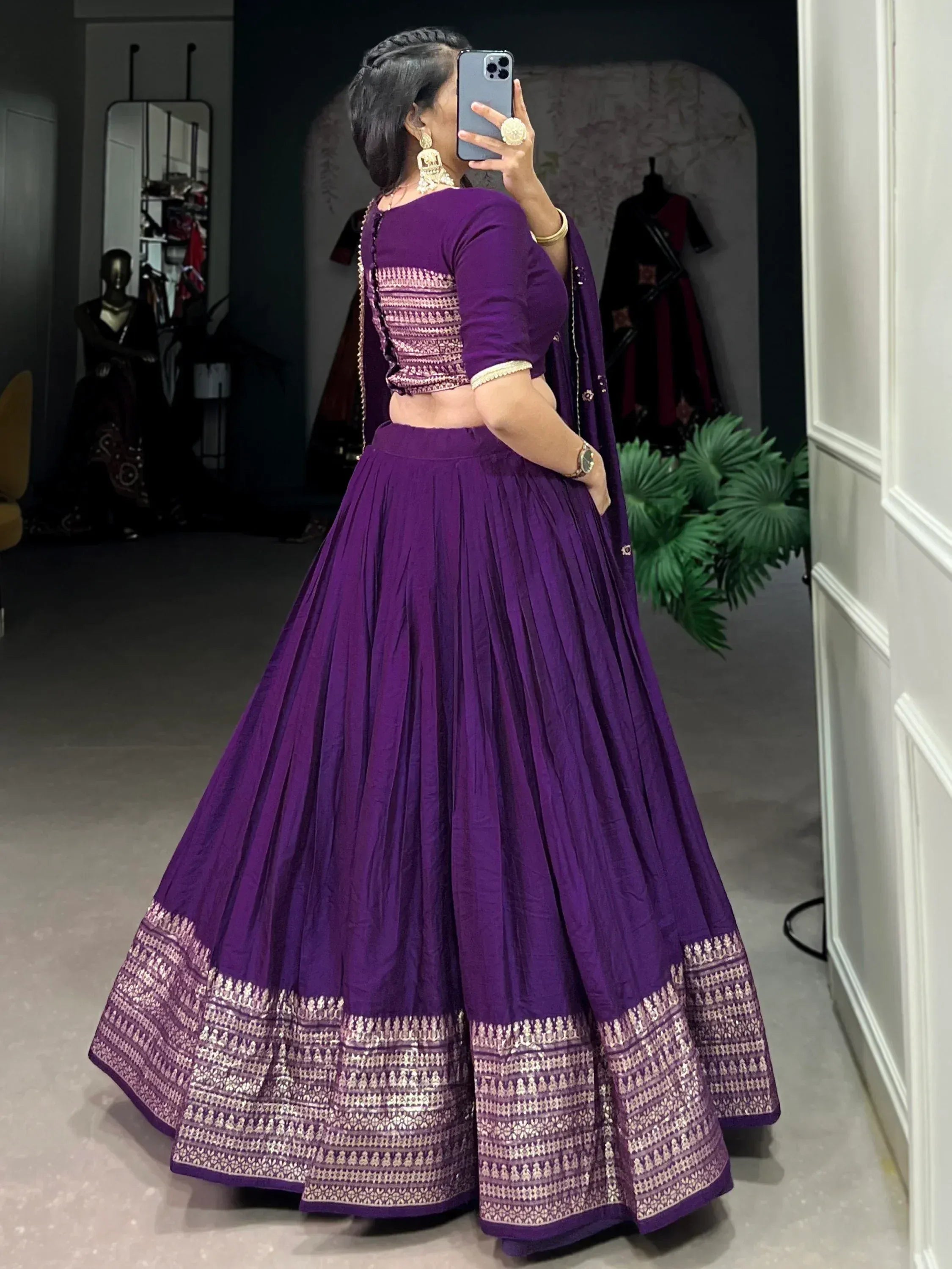 Purple lehenga choli with gold embroidery, mirror selfie in boutique