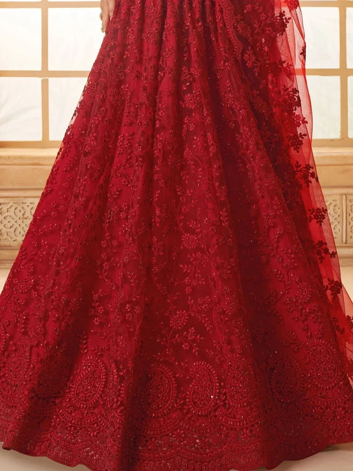 Red embroidered lehenga with floral and paisley motifs, perfect for Indian ethnic wear occasions