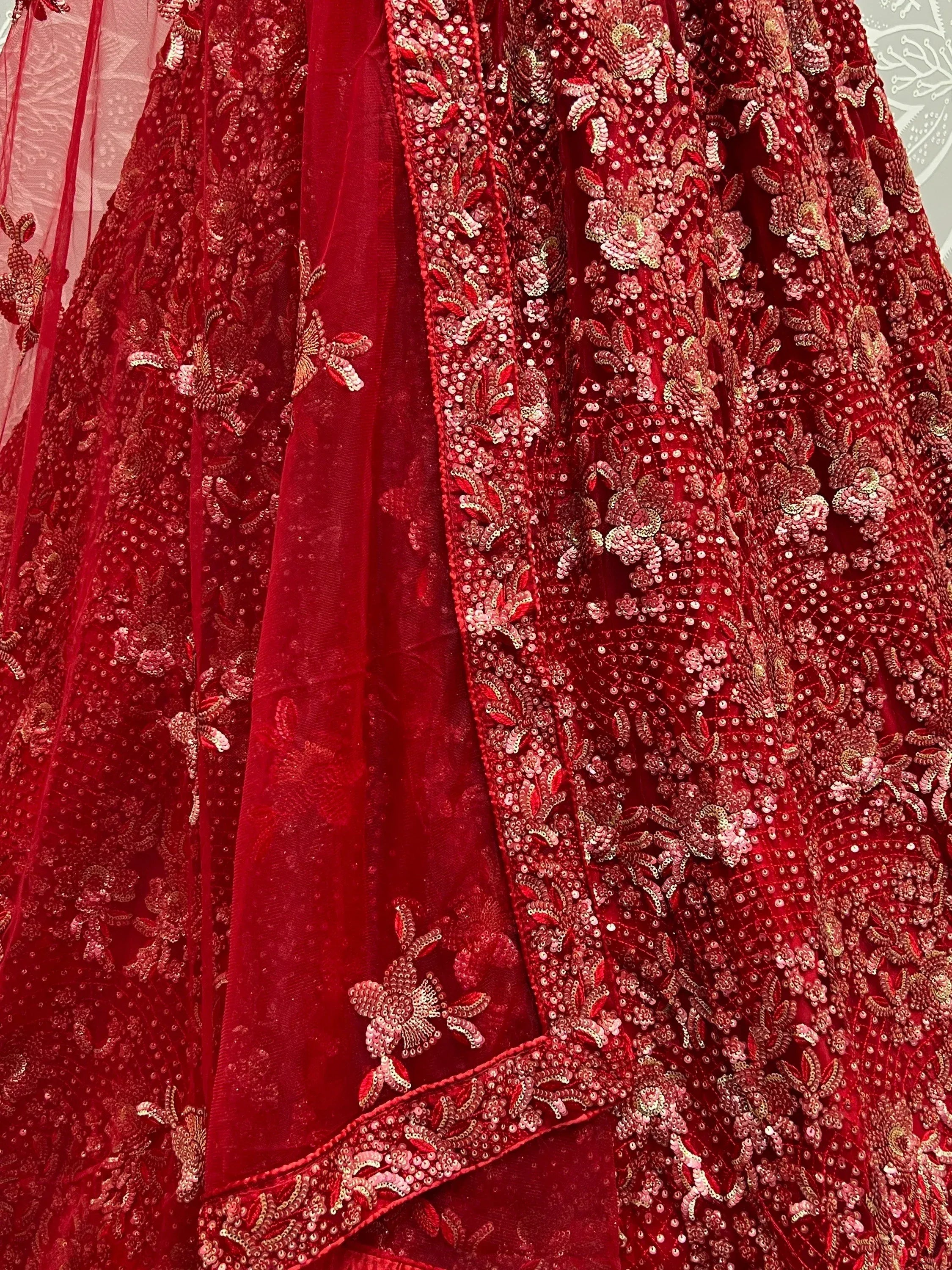 Red velvet lehenga choli with intricate gold sequin embroidery and floral detailing