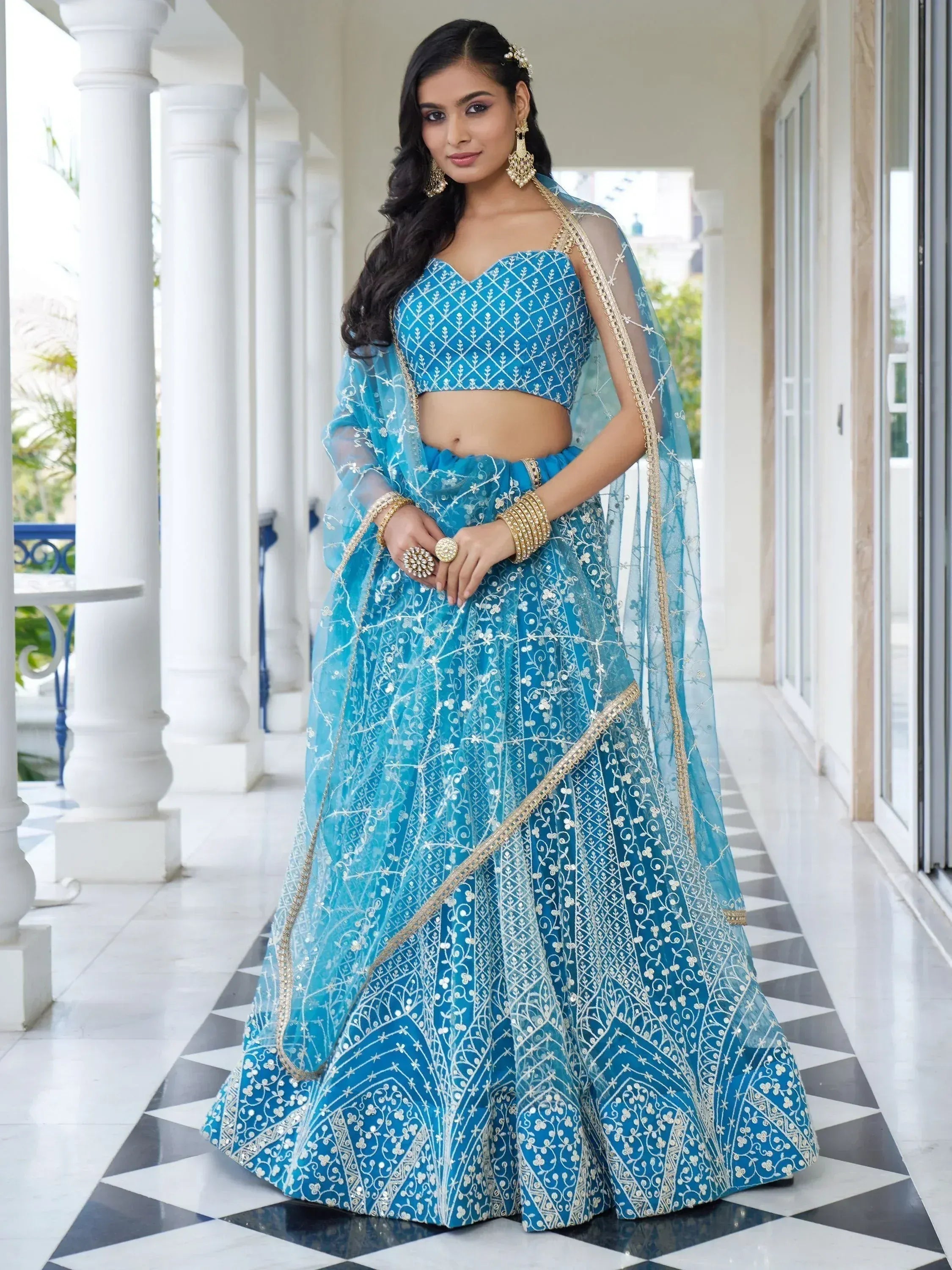 Blue embroidered lehenga choli with gold detailing, perfect for Indian weddings and festive occasions