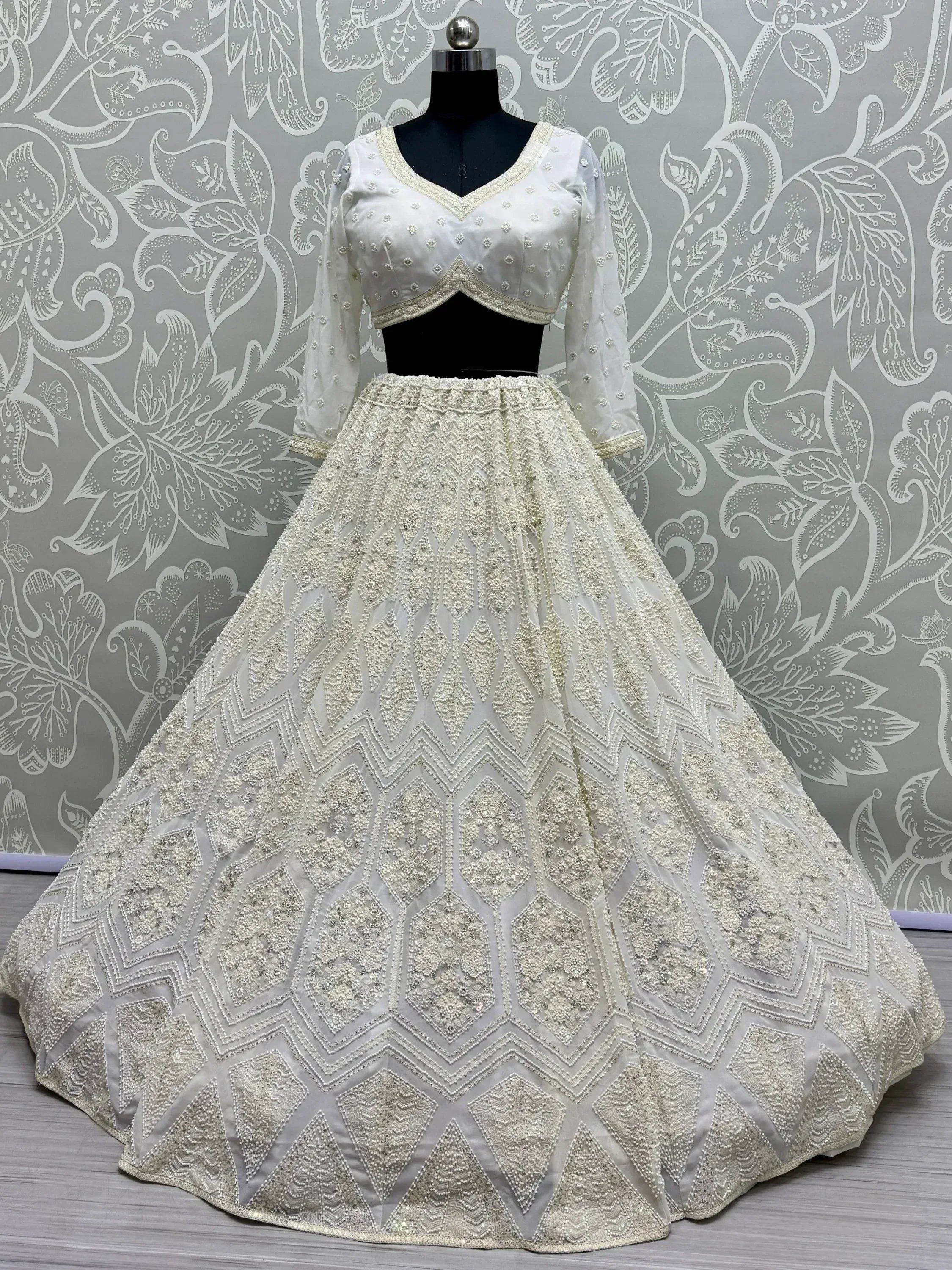 White embroidered lehenga choli with geometric beadwork, perfect for Indian weddings and festive occasions.