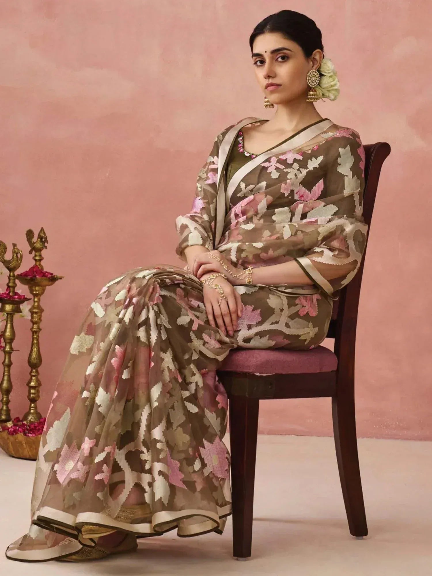 Woman in floral printed saree with pink and beige motifs, traditional Indian ethnic wear